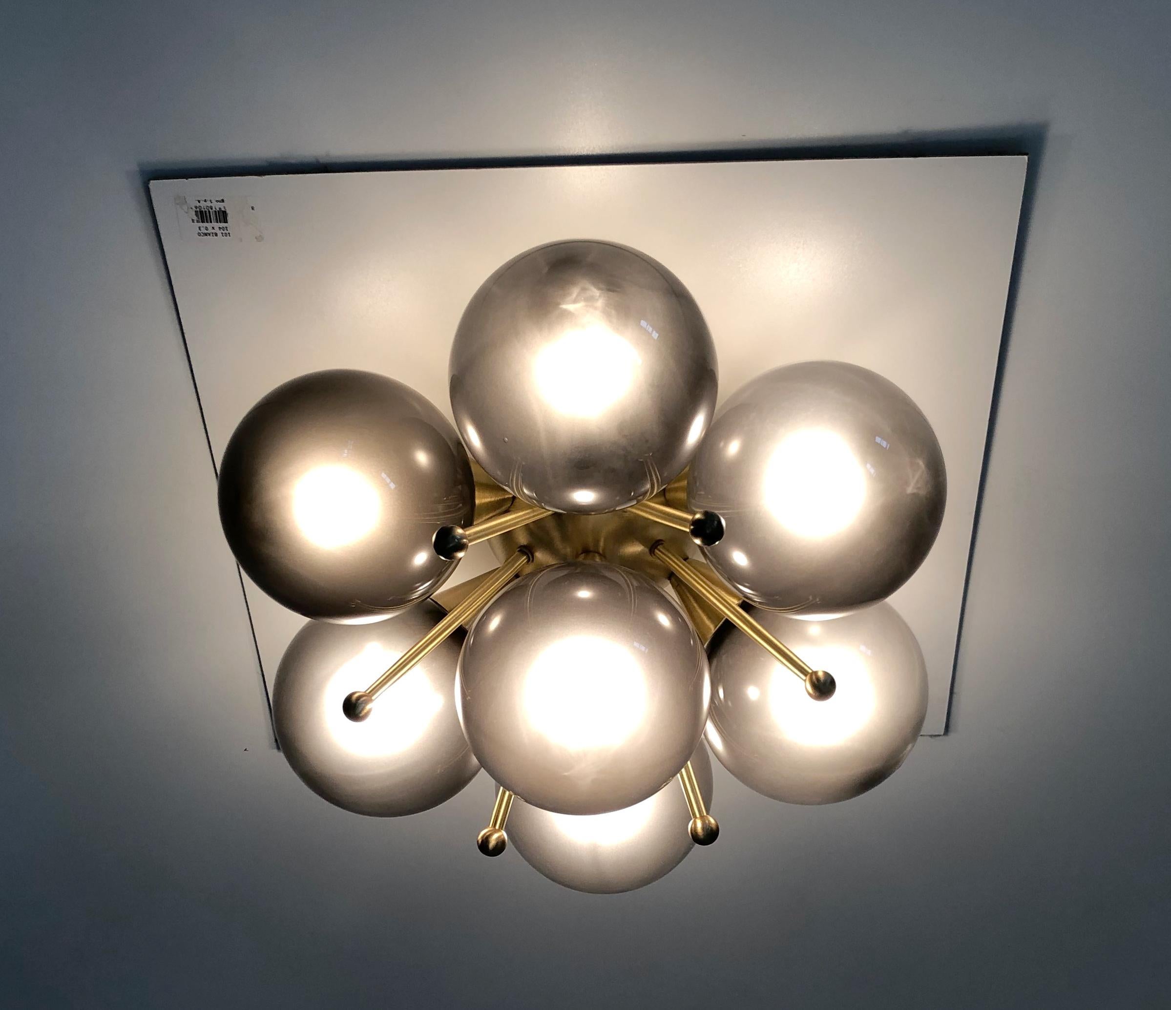 Italian flush mount with Murano glass globes mounted on solid brass frame 
Designed by Fabio Bergomi / Made in Italy 7 lights / E12 or E14 type / max 40W each 
Diameter: 22 inches / Height: 11 inches 
Order only / This item ships from Italy 
Order