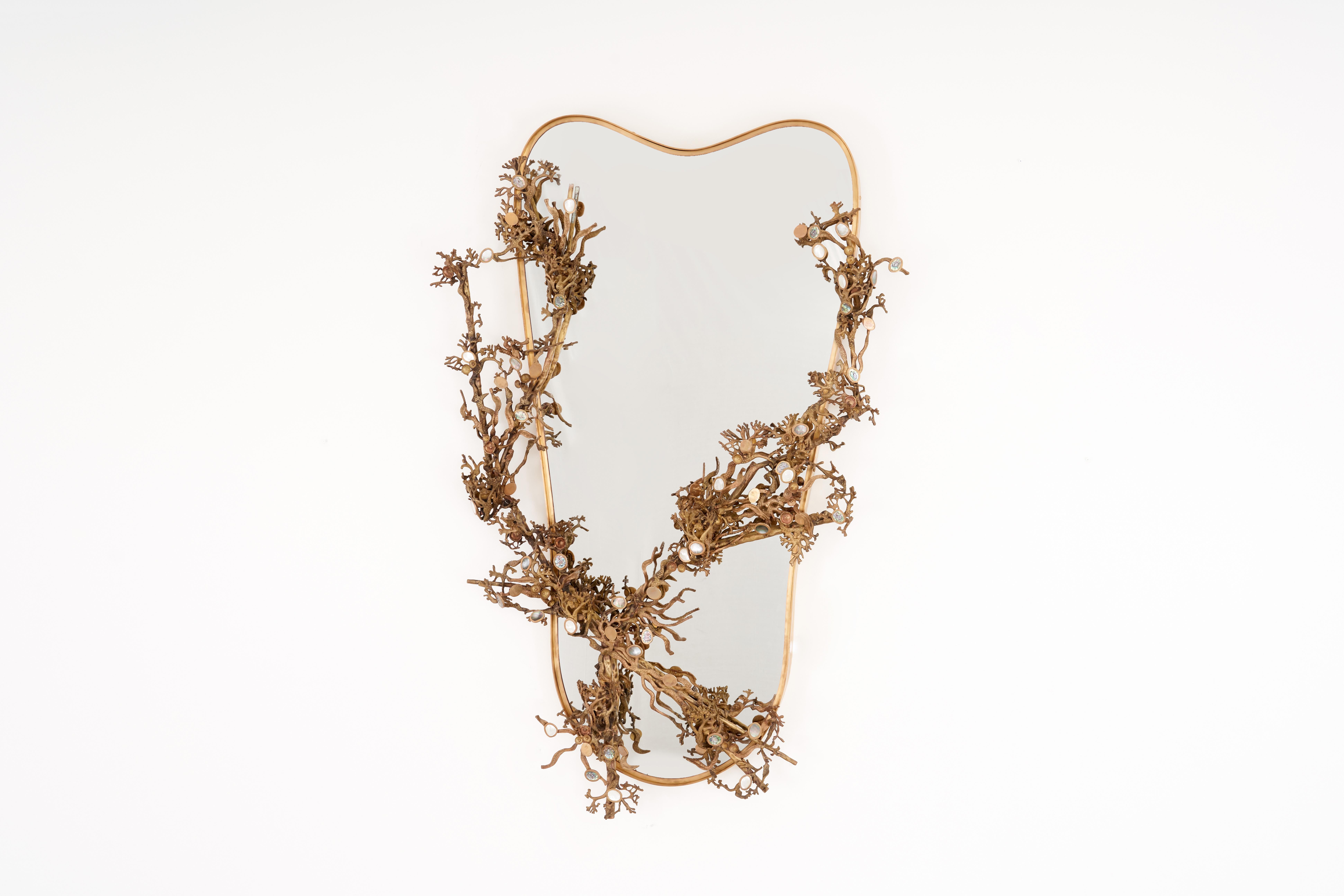 Inspired by the lush, flowering branches of the Japanese Sakura in springtime, this Baroque-style mirror features cast brass branches entwined around its frame. The Cherry Blossoms—which are delicate ornamental flowers—are represented by highlights