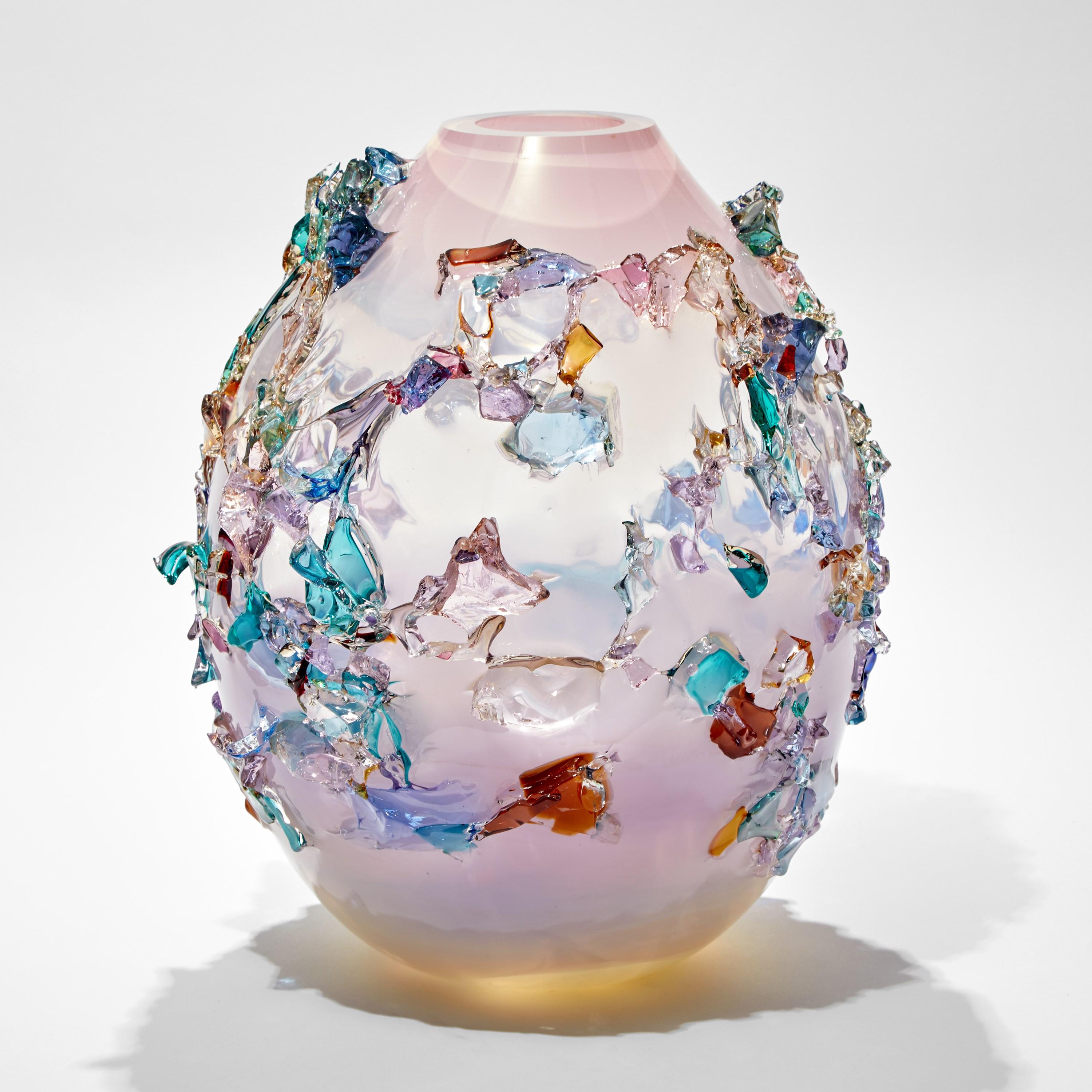 Sakura TRP21010 is a unique pink and multicolored hand-blown art glass sculptural vase, covered in an organic glass shard adornment by the Dutch artist Maarten Vorlijk. The piece is flame polished to soften the edges of all the additional external