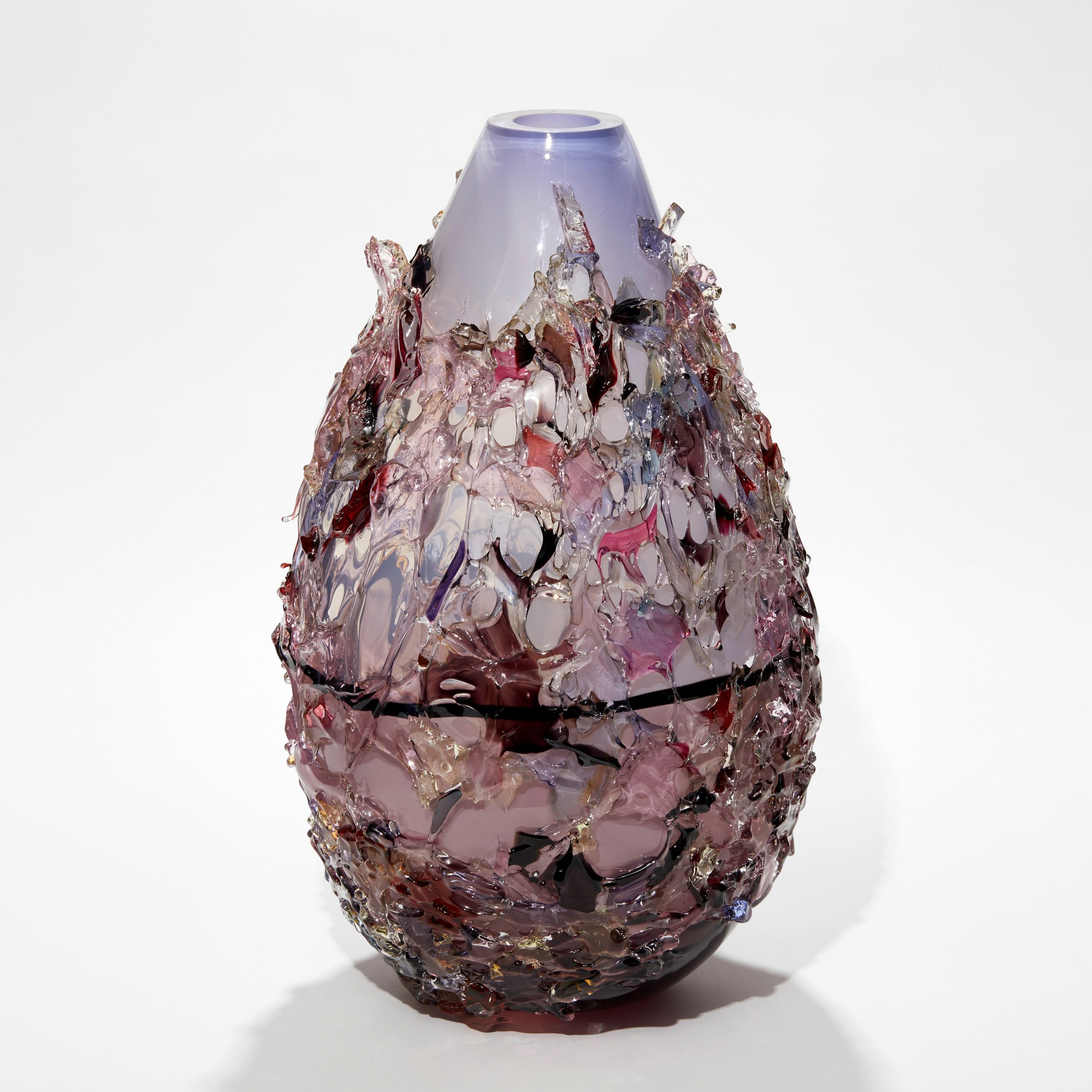Sakura TRP22018 is a unique aubergine and lilac and multicolored hand-blown art glass sculptural vase, covered in an organic glass shard adornment by the Dutch artist Maarten Vorlijk. The piece is flame polished to soften the edges of all the