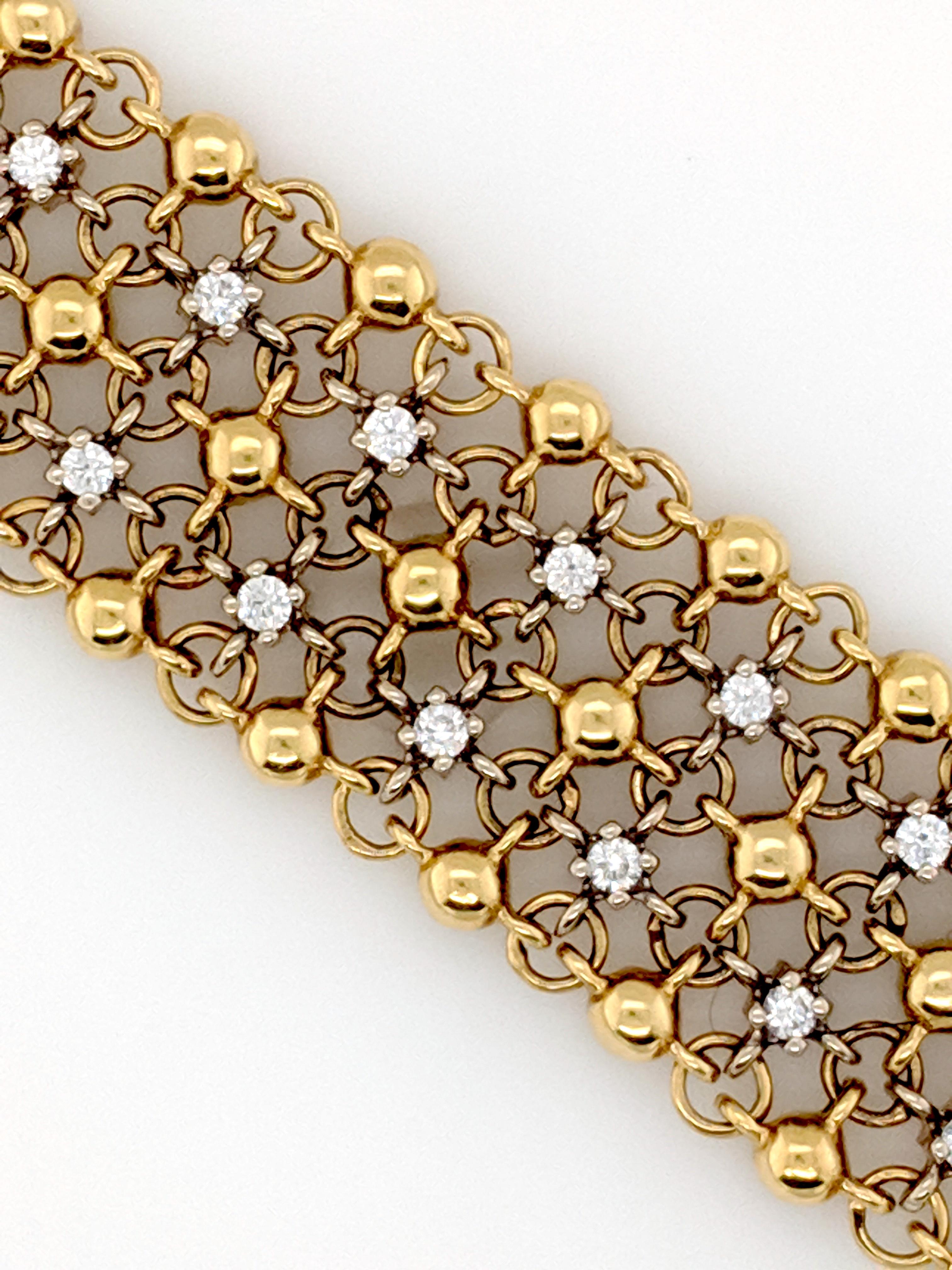 This Diamond bracelet designed by Sal Praschnik has been crafted in 18k yellow gold and 18kwg diamond plate and contains (38) round diamonds weighing approximately 1.90cttw with a color of G/H and a clarity of SI1. The bracelet measures 7