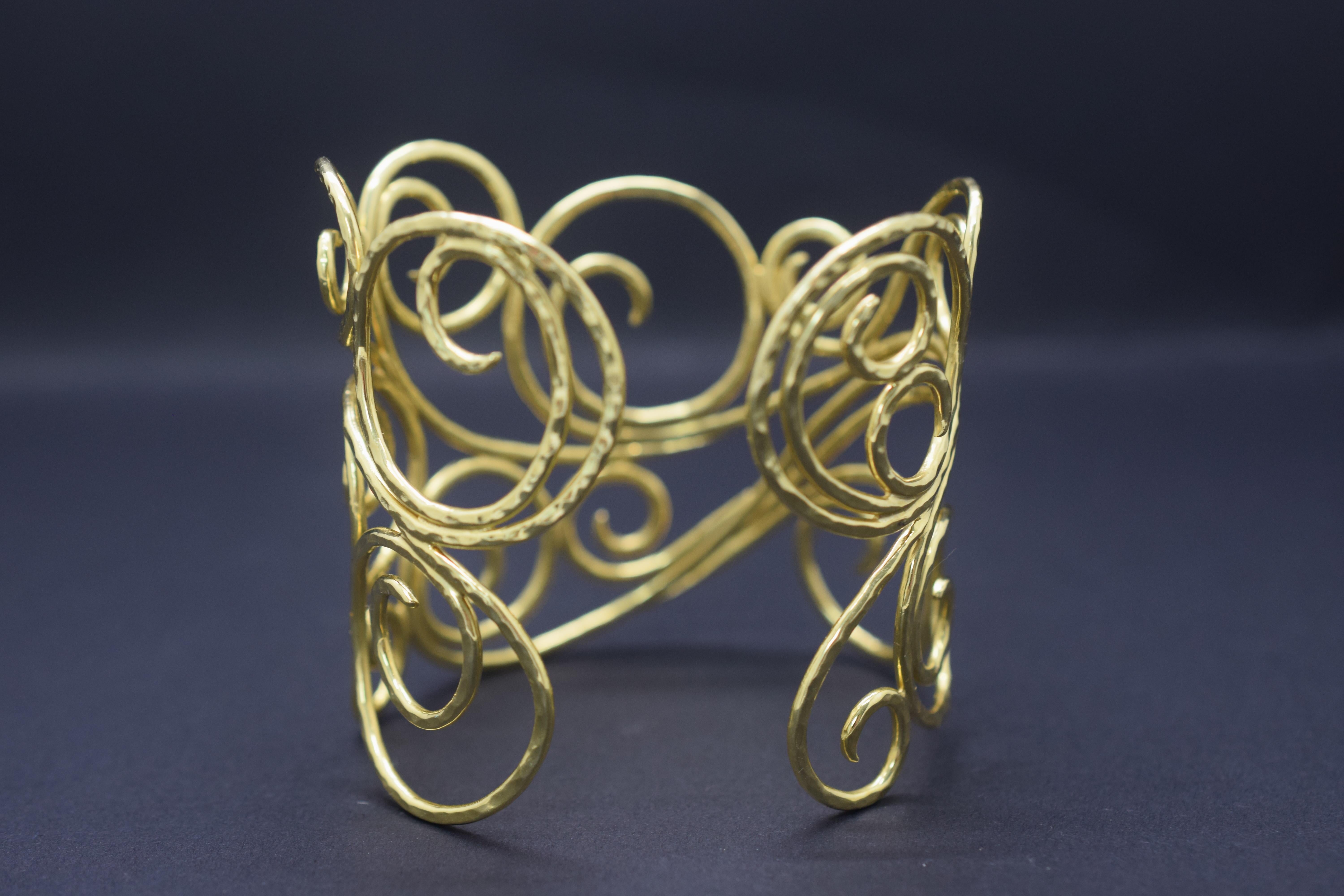 This hand crafted cuff bracelet is crafted by famed designer Sal Preschnik. It is 18k yellow gold and is from his 