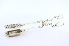 Salad, bread or sauce tongs in cut-out silver