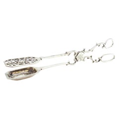 Salad, bread or sauce tongs in cut-out silver