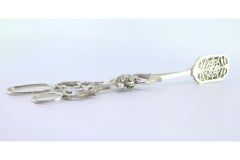Salad, bread or sauce tongs in scalloped silver