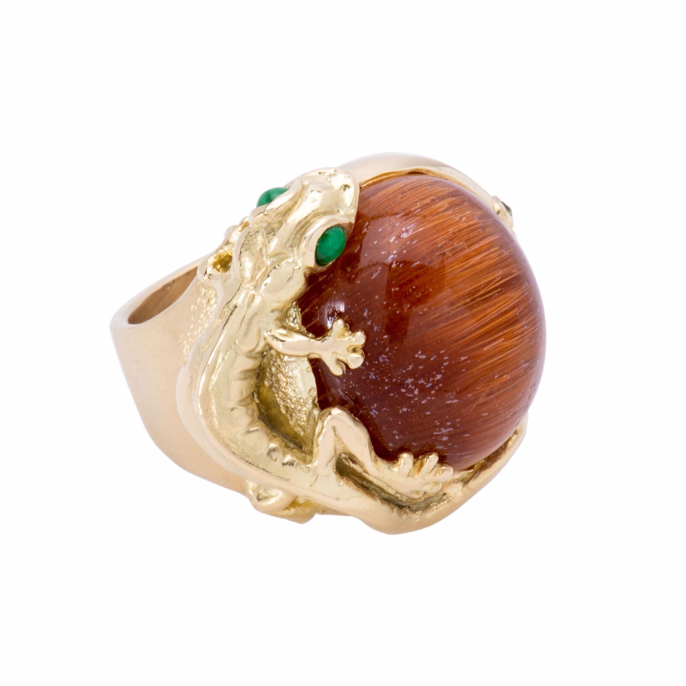 The little salamander with jade eyes wraps herself around this gorgeous 21ct rutilated quartz ring. She reaches for single peridot on the far side. Handcrafted in 18k gold, this dome ring is currently a size 7.5. Total weight of the Salamander