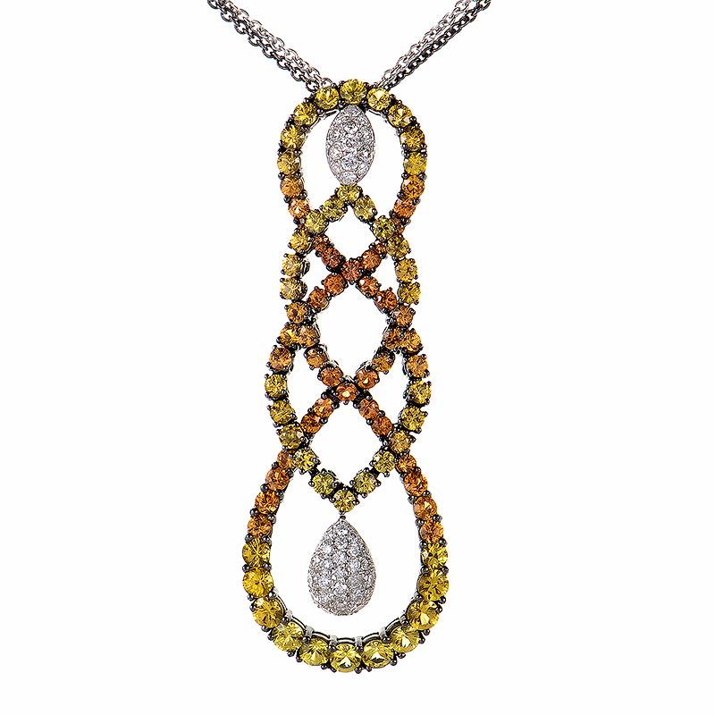 This pendant necklace from Salavetti is exceptionally gorgeous and unique. The necklace is made of 18K white gold and is partially dipped in black rhodium. The pendant has an interwoven design and is set with ~7.49ct of yellow and orange sapphires