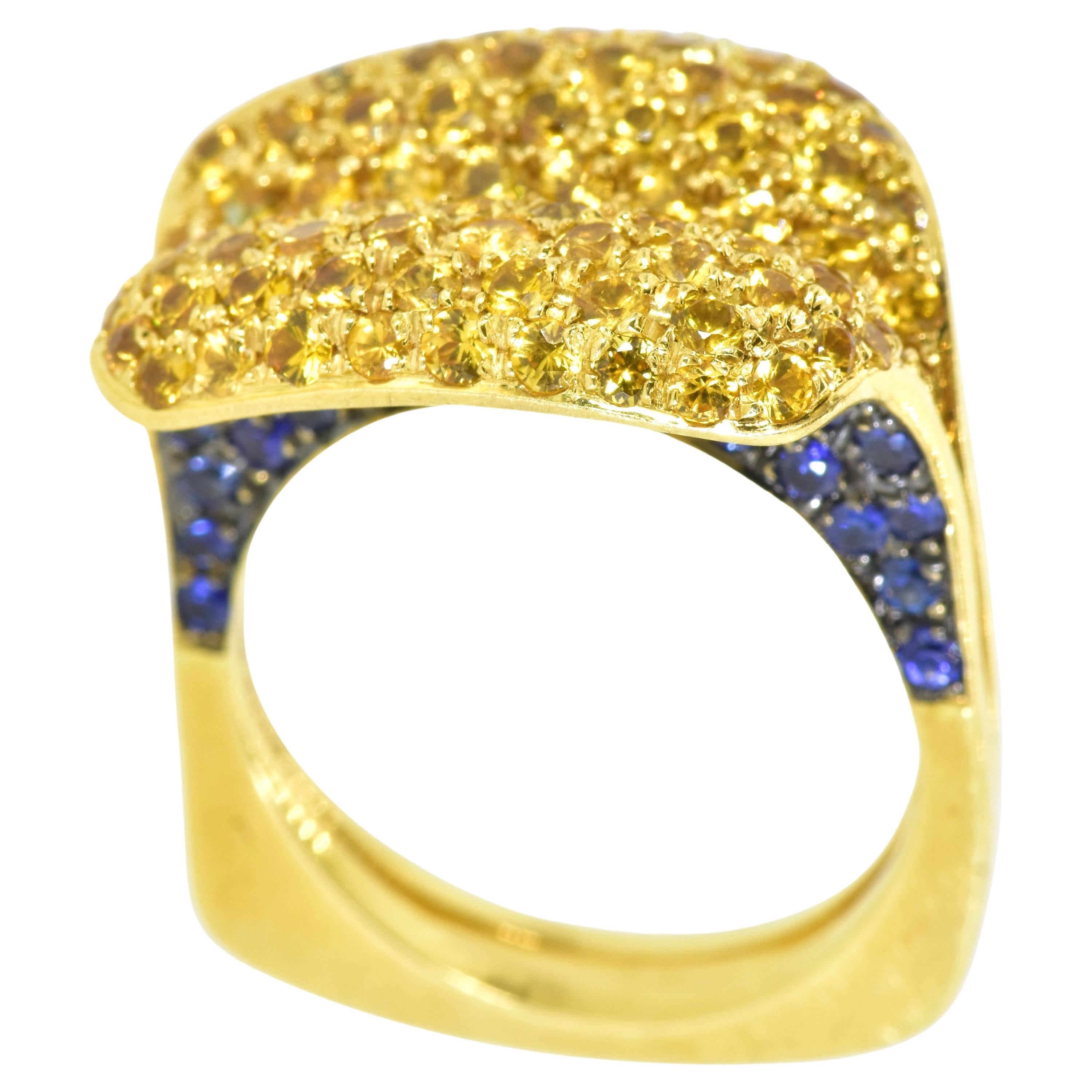Yellow and blue sapphires set in 18K yellow gold in a very inventive ring by the jewelry designer Salavetti - known for their use of fine materials. The pave set natural golden (yellow) sapphires are a bright pleasing daisy yellow.  The  natural