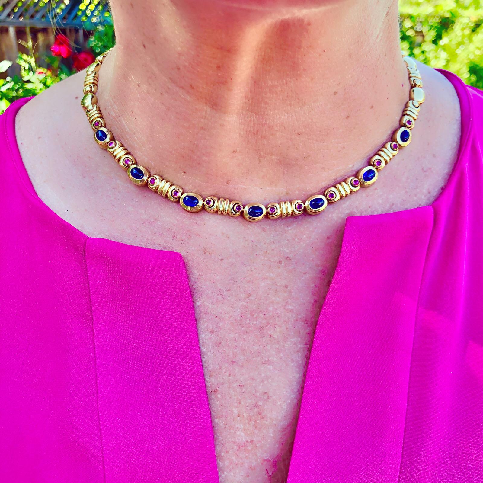 Contemporary Salavetti 18Kt Yellow Gold Necklace Adorned with 3.50 Carat Total Weight of Oval Cabochon Cut Sapphires and 0.70 of Cabochon Cut Rubies. This stylish choker measures 16 inches long and 6.35mm wide, weighing 67.0 grams.