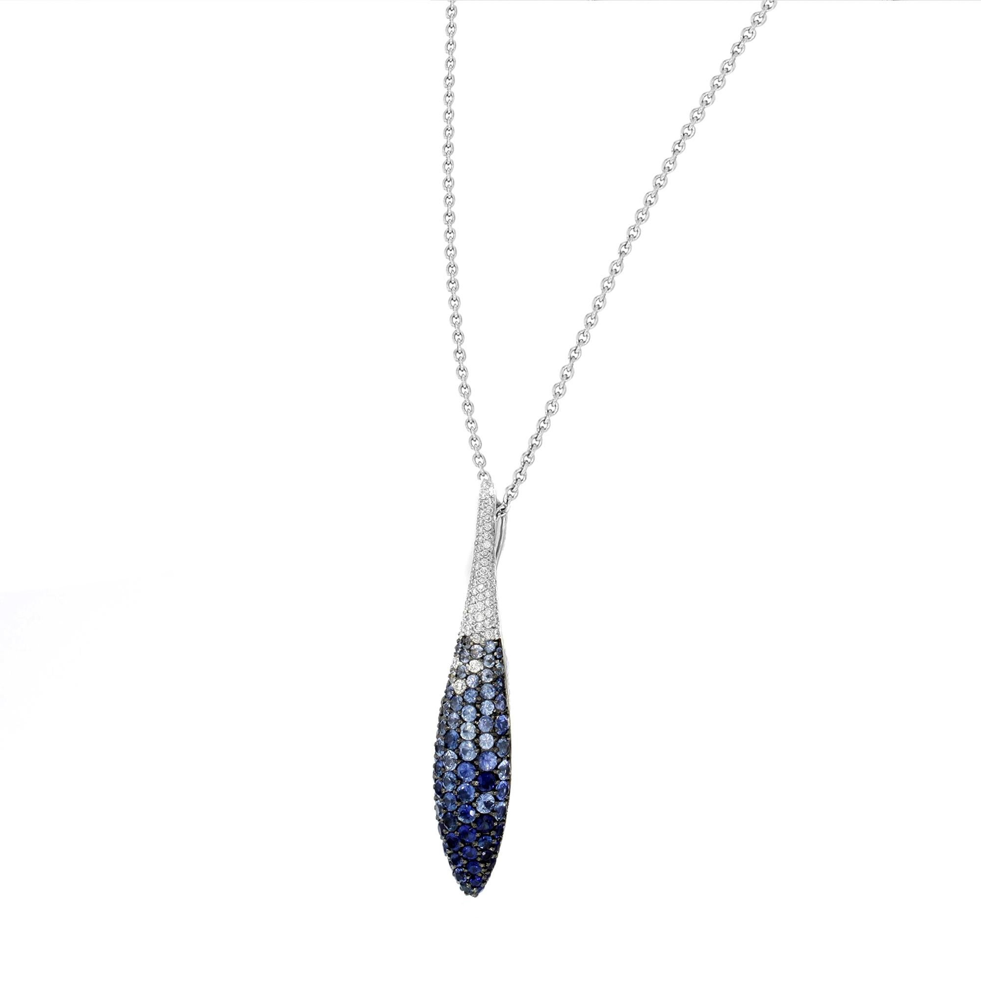 This beautiful necklace is crafted in 18K white gold with pave set round cut diamonds weighing appx. 0.28 cttw. and round cut blue sapphires weighing 1.98 cttw. Chain length: 16 inches. Pendant length: 40 mm, width: 7.25 mm, thickness: 5.25 mm.