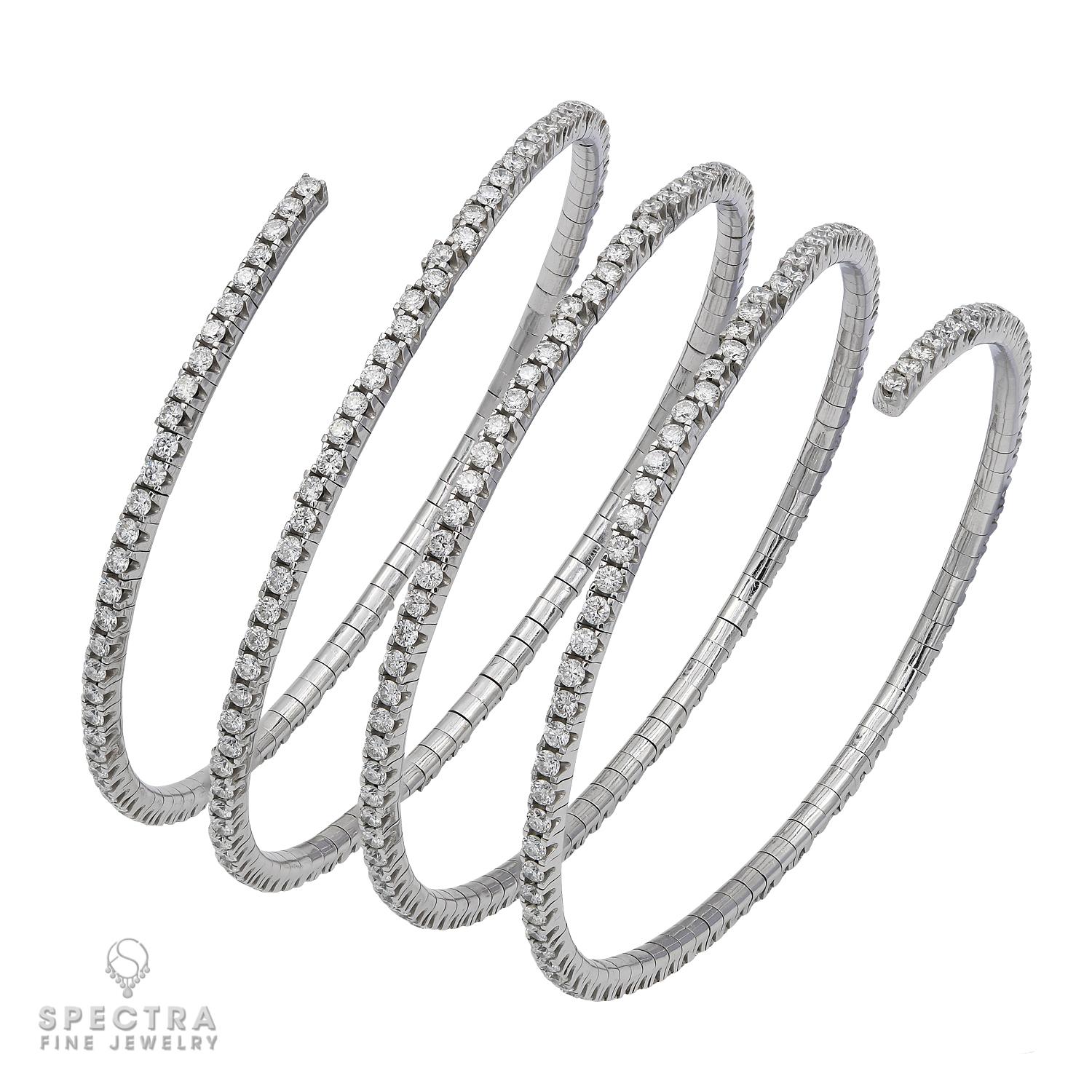 This minimalist Salavetti Diamond Coil Bangle, made in Italy in the Contemporary era, circa 2010s, is a piece reduced to its essence, and as such is utterly stylish, sexy, and versatile. Crafted in 18K white gold set with approximately 13.35 carats