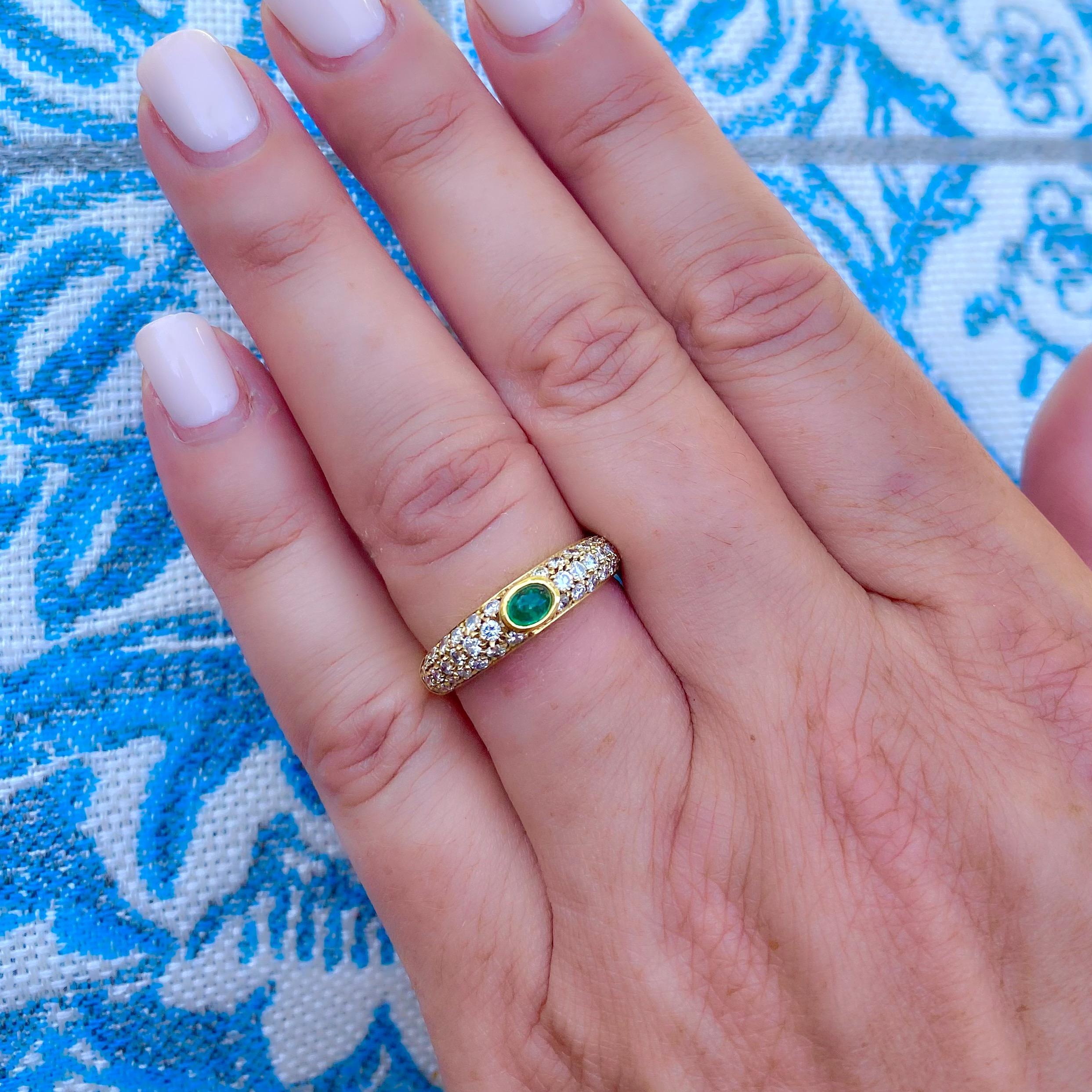 Of classic 1970's style, this 18k yellow gold narrow domed ring centers a bezel-set oval emerald cabochon weighing 0.22-ct., with pave-set round brilliant-cut diamonds weighing in total 0.63-ct. The ring weighs 4.6 grams, and is currently size 7.5,
