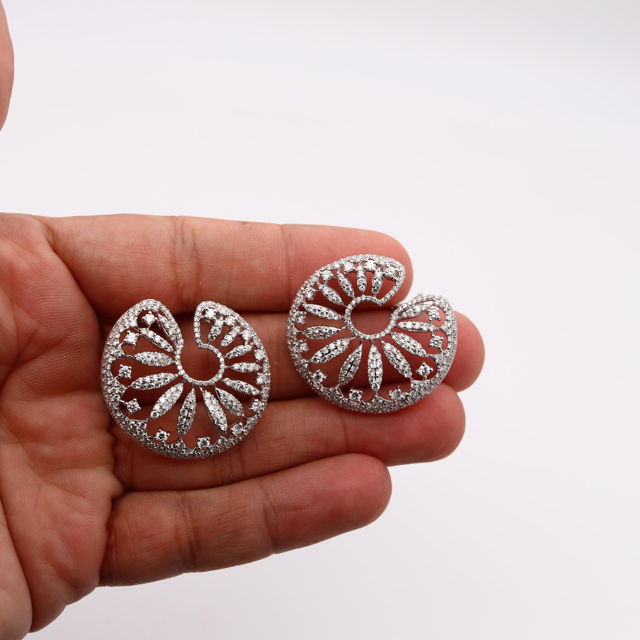 Exceptional pair of clips earrings designed by Salavetti. 

Gorgeous one-of-a-kind pair created in Milan, Italy by the jewelry house of Salavetti. They are crafted, with intricate patterns in solid white gold of 18 karat and suited with European