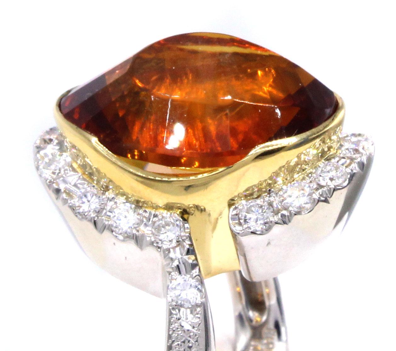 Uniquely designed and masterfully handcrafted this bold 1970s creation features an intense orange Madeira Citrine weighing 16.72 carats. The abstract cut of this gemstone reminds one of the shape of a volcano or mountain, with a partially smooth