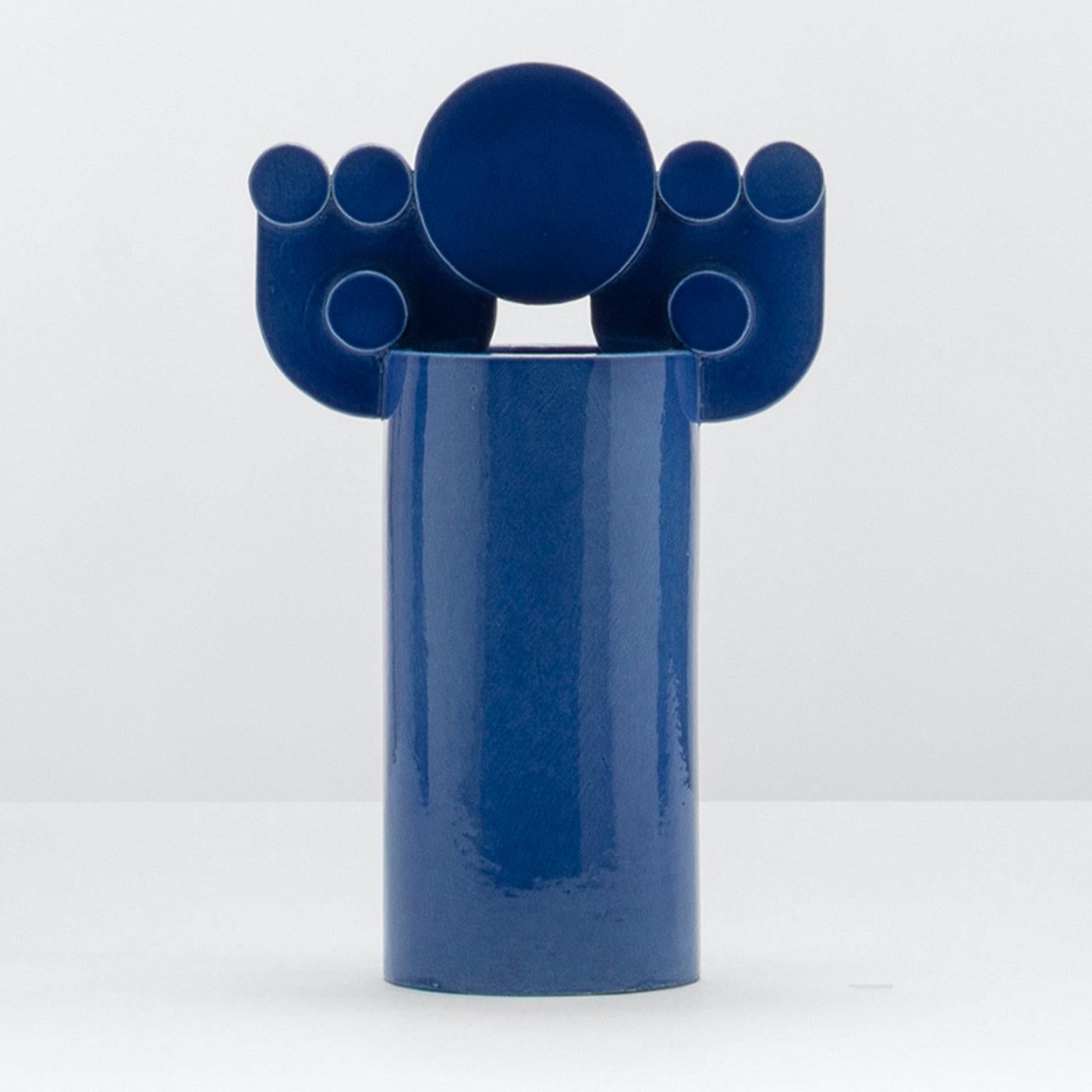 Inspired by the movement of waves hitting the shore and disappearing in the sand, this cobalt blue vase is an abstract transposition that plays with the balance of geometries. The design belongs to the Bubble Family Collection, a series celebrating