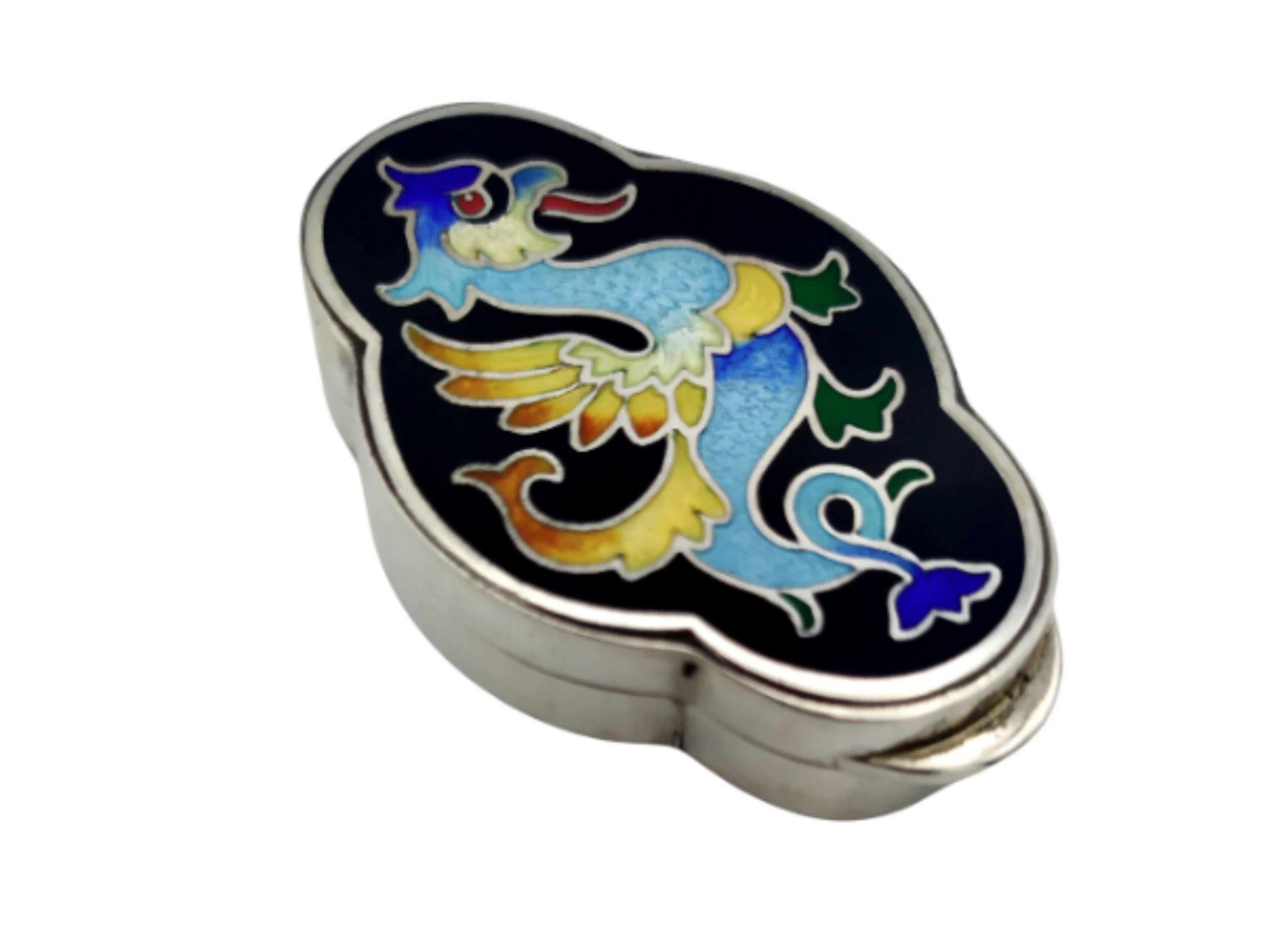 
Salimbeni Pillbox Dragon in 925/1000 sterling silver with polychrome fire enameled , Art Deco style. Measures 3.5 x 5 x 1.2 cm. Weight gr. 38. Salimbeni Pillbox Dragon was designed in 1985 and produced at the Salimbeni Company with workmanship by