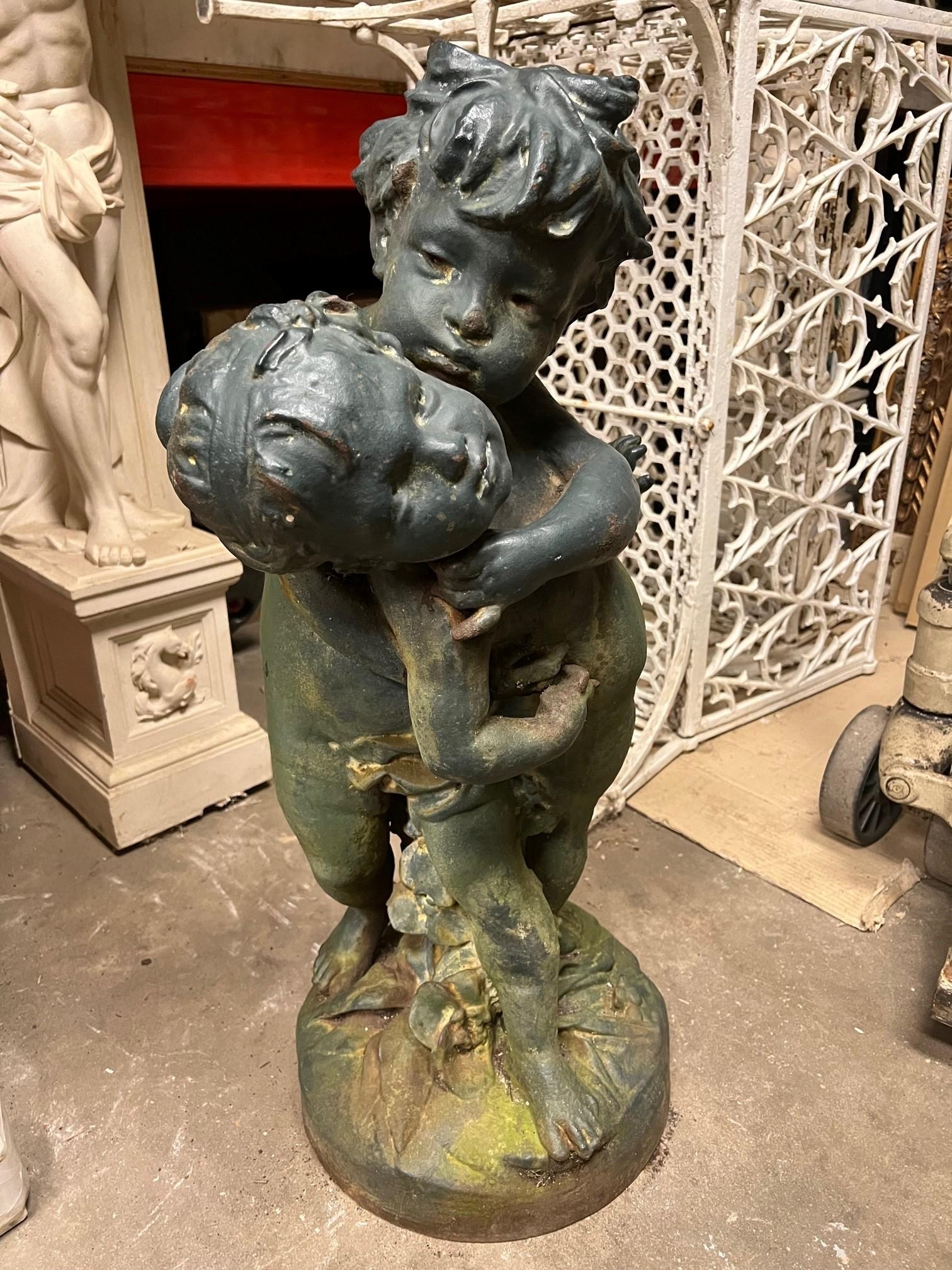 Cast Iron statue of two boys playing by the Salin Foundry in Paris France. The Salin Foundry has a long history dating back to 1806 by the Vivaux brothers. The foundry was taken over by Mr Auguste Salin and became the Salin Foundry in 1875. The