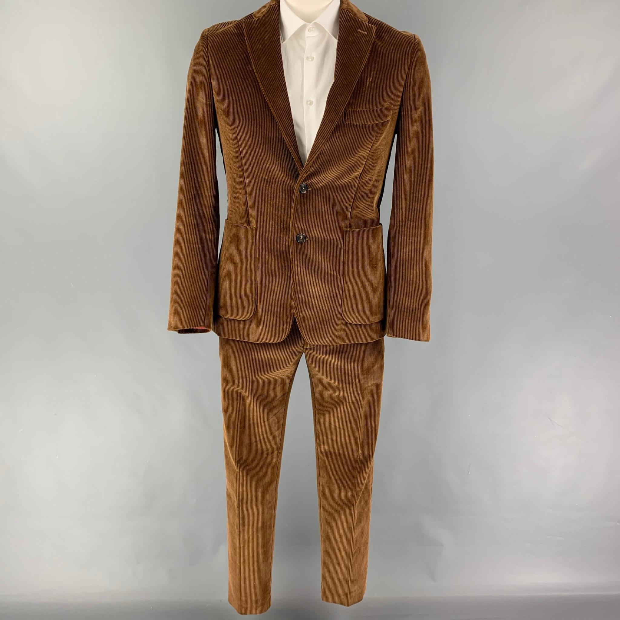 SALLE PRIVEE suit comes in a brown corduroy cotton with a full liner and includes a single breasted, double button sport coat with a notch lapel and matching flat front trousers.

Very Good Pre-Owned Condition.
Marked: