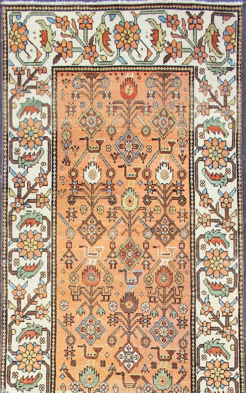 Persian Salmon Background and Earth Tone Antique Bakitari Rug with All-Over Patten For Sale