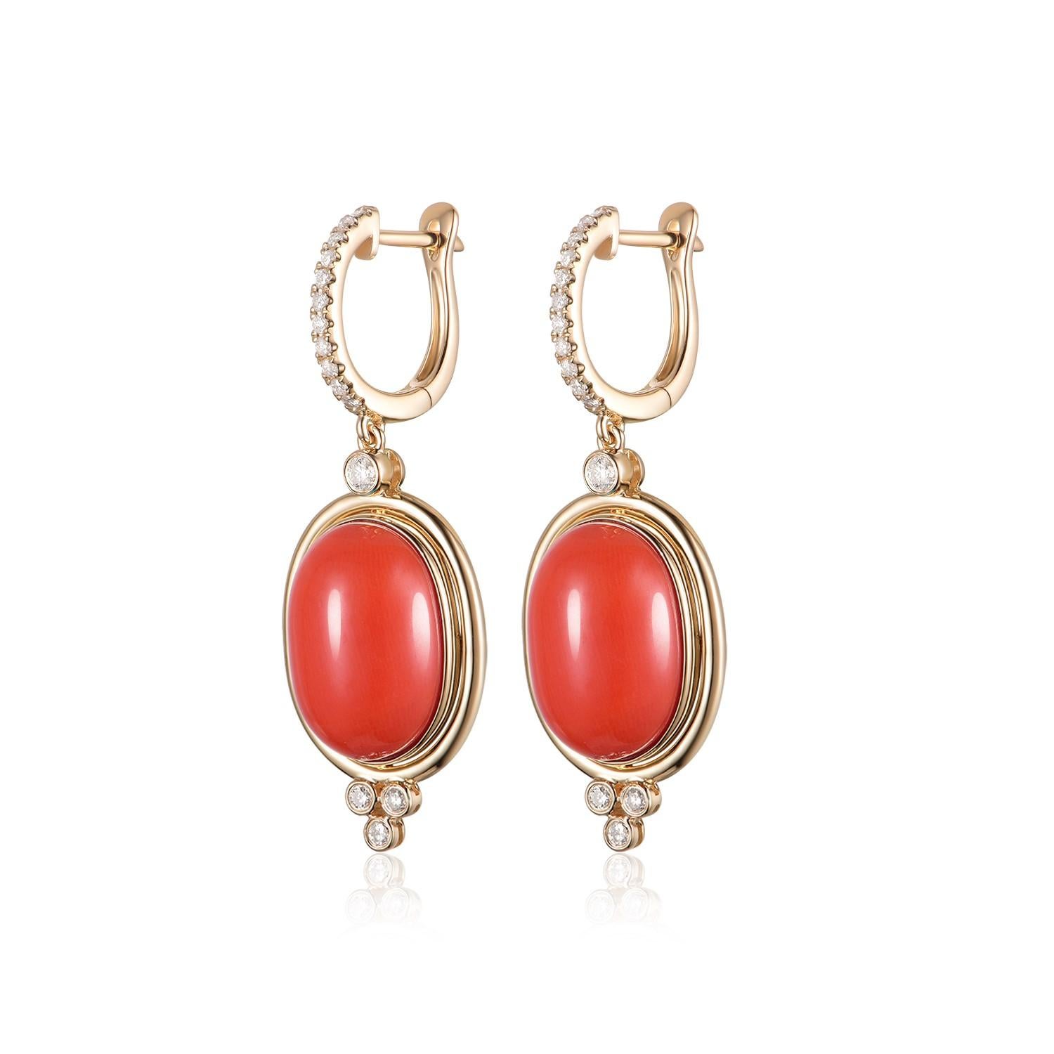 Crafted with impeccable precision, these drop earrings are a testament to the perfect blend of nature's beauty and human artistry. At the heart of this ornate creation lies the salmon-colored coral, weighing an impressive 12.85 carats. This shade of