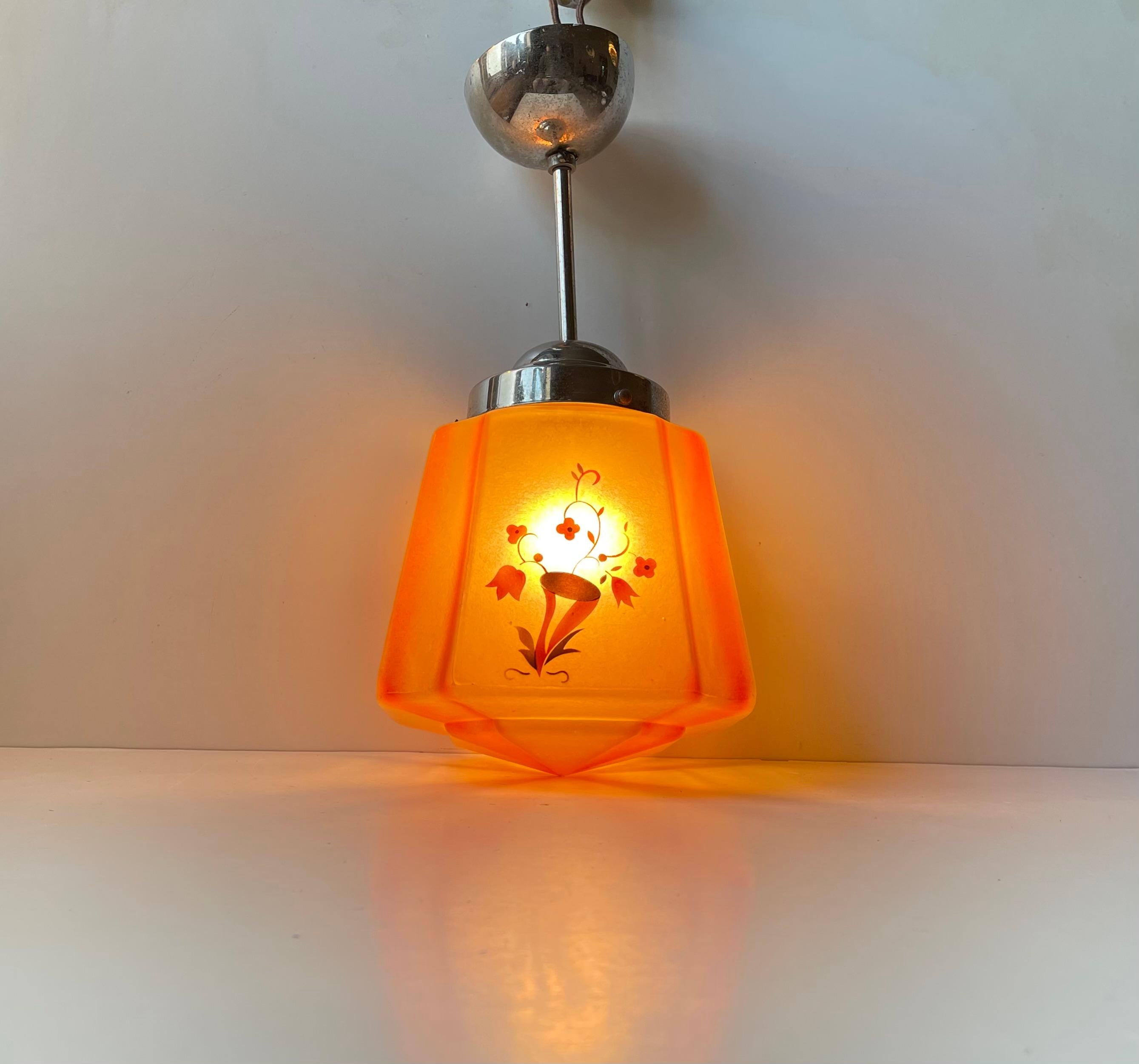 Elegant hanging pendant light composed of a hand-painted glass shade decorated with floral motifs. It features its original nickel plated shade-holder, rod, canopy and socket in brass and porcelain. It was manufactured in Scandinavia during the