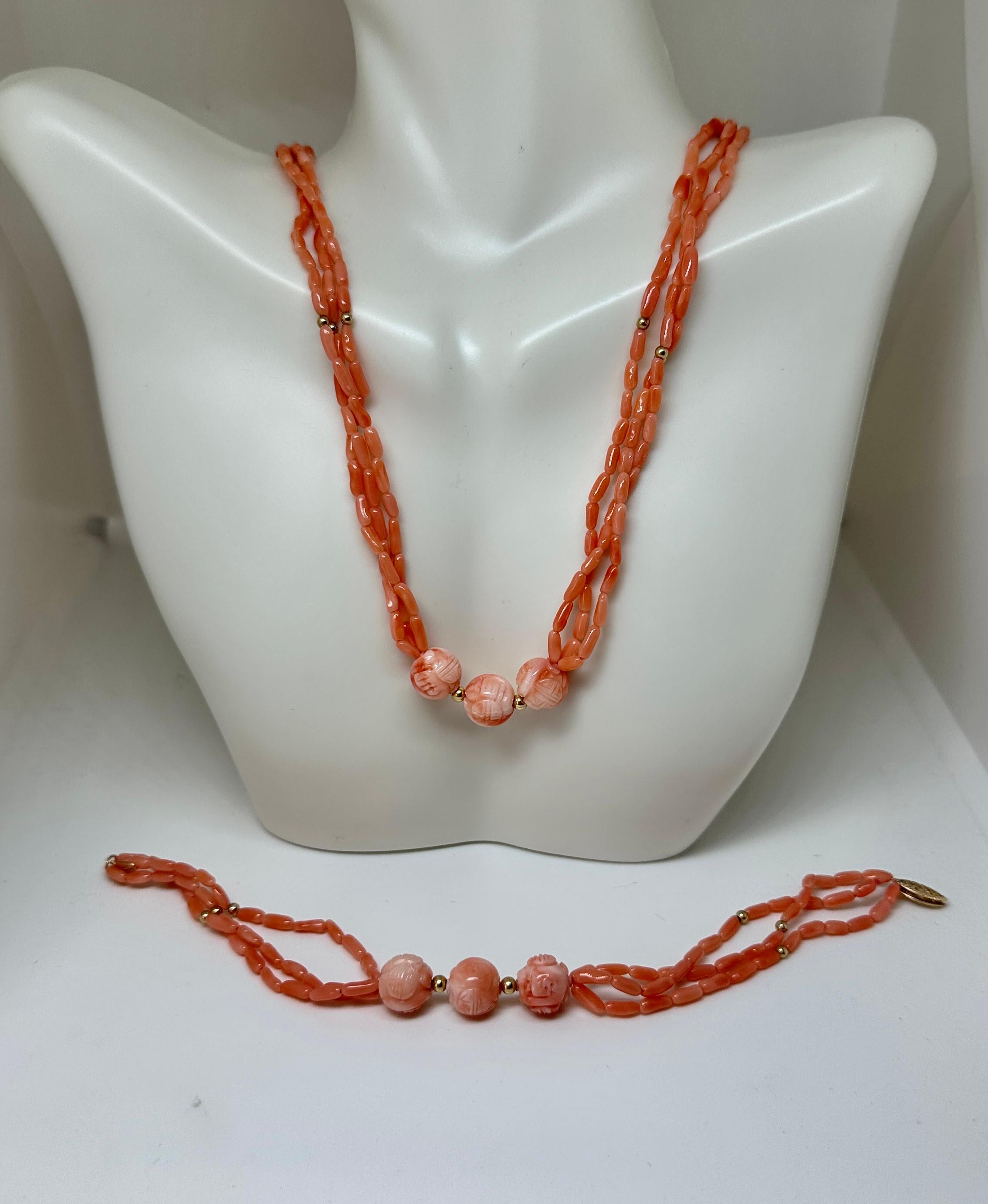 This is a stunning antique salmon colored Coral and 14 Karat Gold three strand Torsade Necklace and Bracelet with beautiful hand carved Coral beads of great beauty.  The clasps are 14 Karat Yellow Gold.   The combination of the pink salmon coral