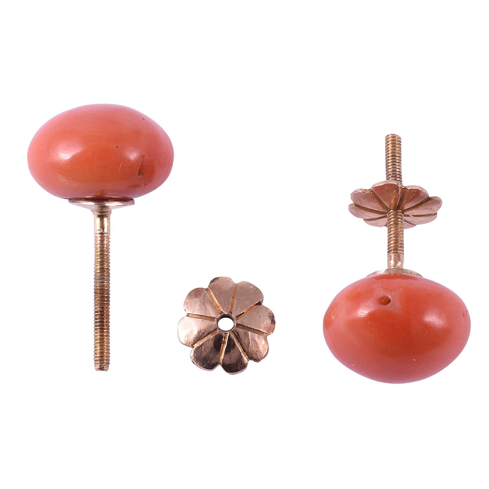Vintage salmon coral stud earrings. These earrings feature button shaped salmon color coral measuring 10mm x 10mm x 6.5mm. The vintage coral earrings have 18 karat gold screw posts and backs. [KIMH 593]