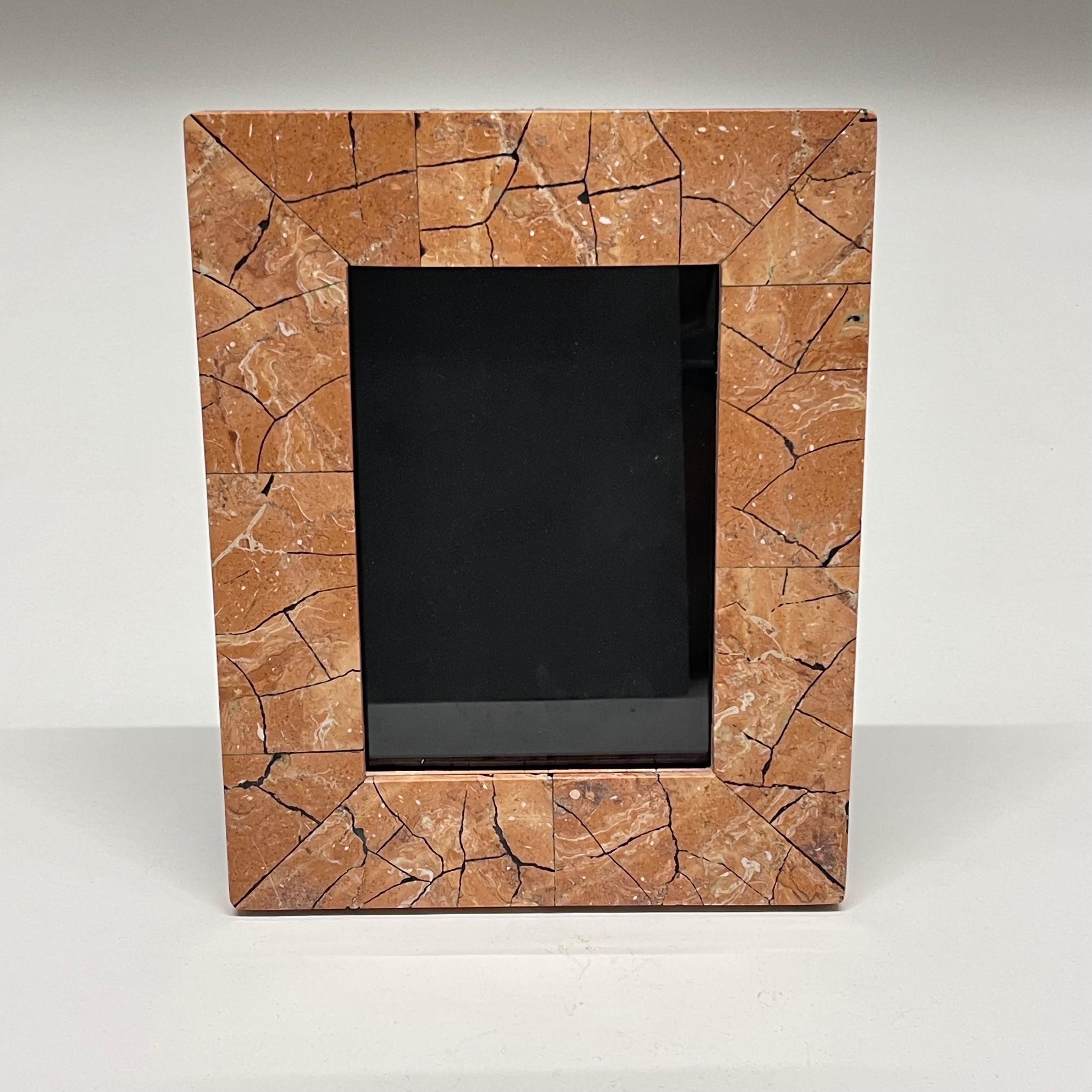 Unique Post Modern picture or photo frame rendered in tessellated mosaic salmon pink travertine stone, lined in black felt velvet, by Maitland-Smith, Philippines, Circa 1980s.