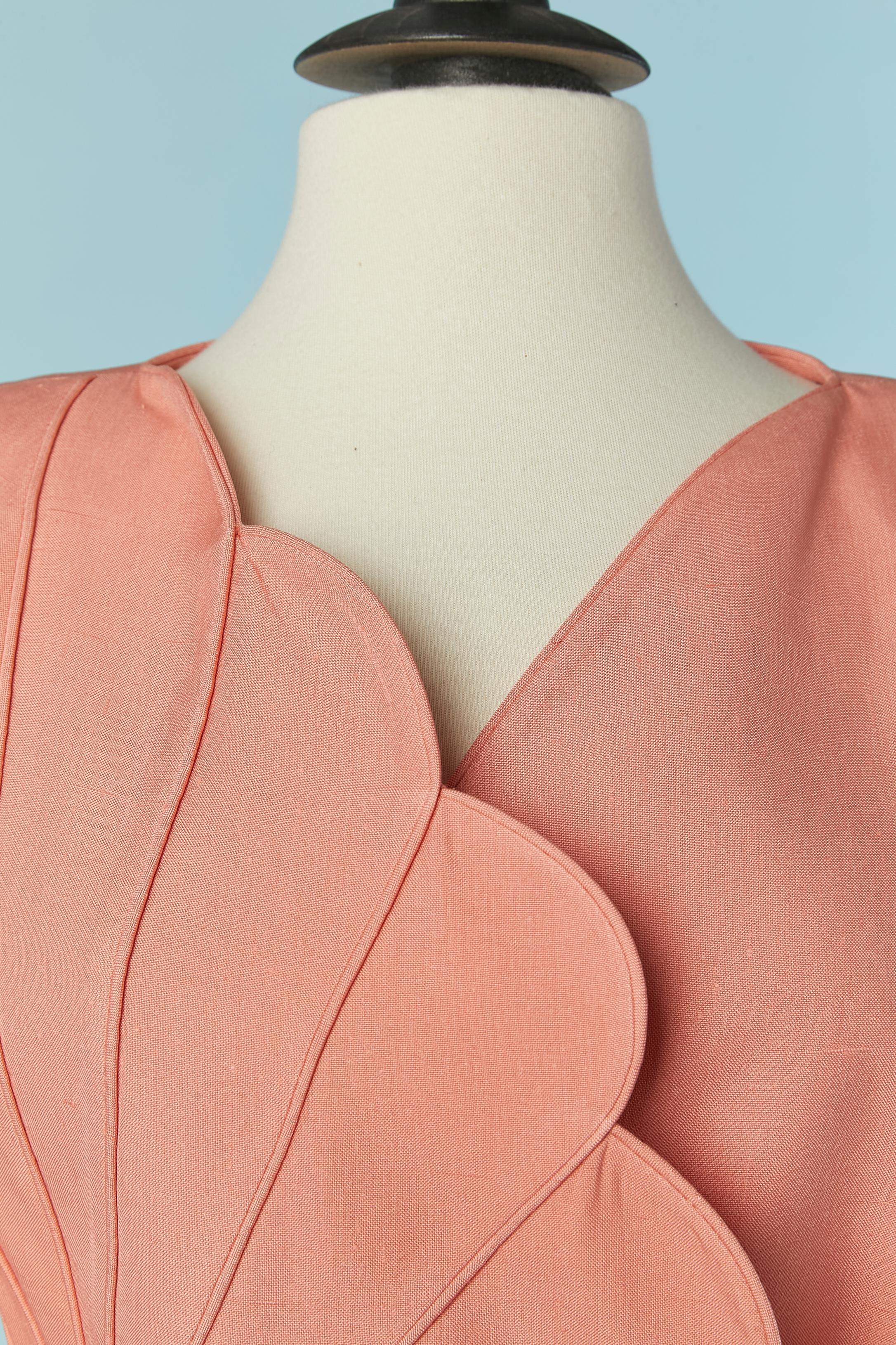Salmon pink raw silk skirt-suit with cut-work . No fabric composition tag for the lining but probably acetate or rayon. 
Shoulder-pad. Double-breasted jacket with button and buttonhole closure + belt in the same fabric. Button and (fake) buttonhole
