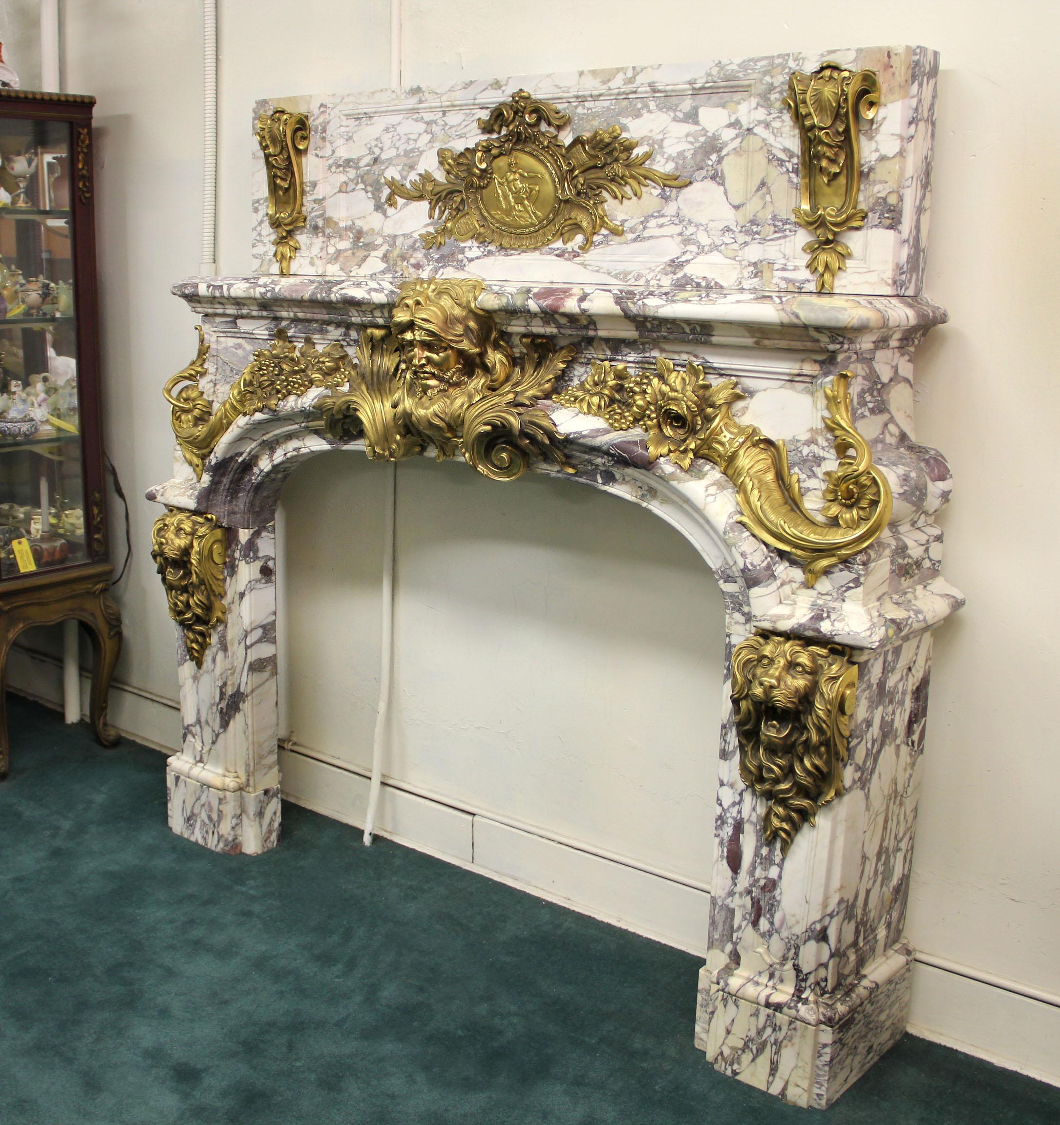 Very important late 19th century gilt bronze mounted palatial fireplace surround.

This fireplace is an exact copy of the original 18th century model that was made for The Salon de Hercules in The Palace of Versailles. After Antoine Vassé.