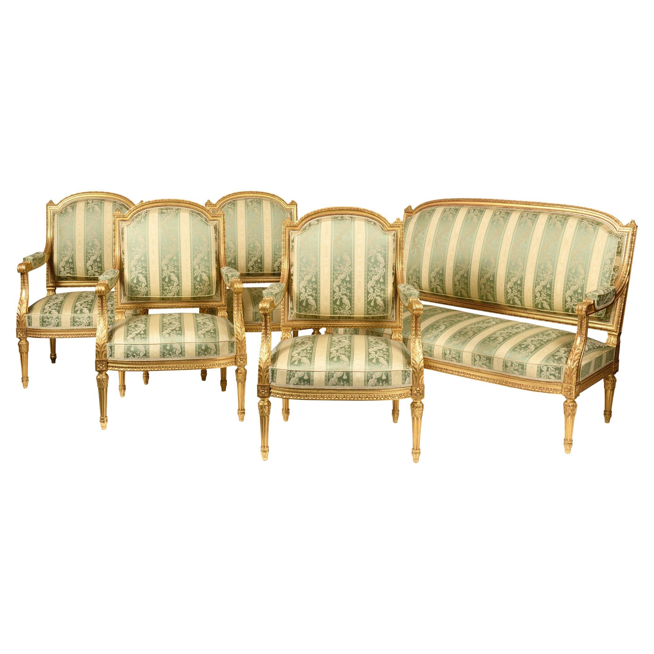 Ensemble de salon comprenant un canapé et 4 fauteuils en bois doré de style Louis XVI en vente
