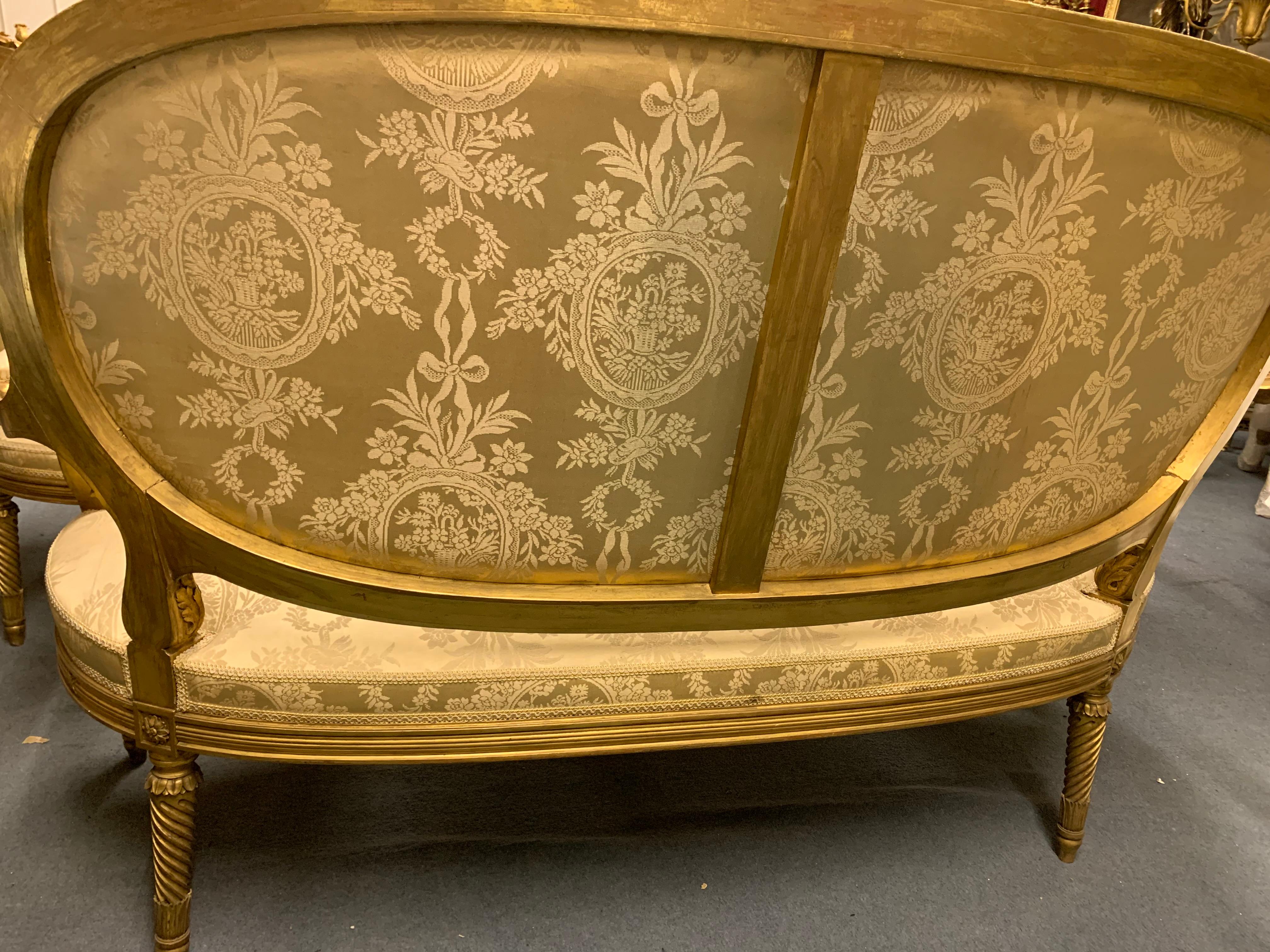 French Salon Set  in Giltwood Comprising Four Armchairs and One Sofa  For Sale