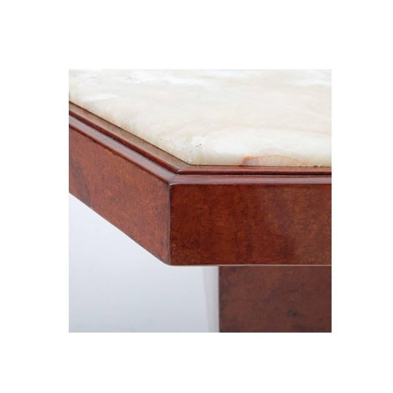 Sechseckiger Salontisch aus Nussbaum mit Marmorplatte, der auf einem leicht geschwungenen Tulpensockel steht.