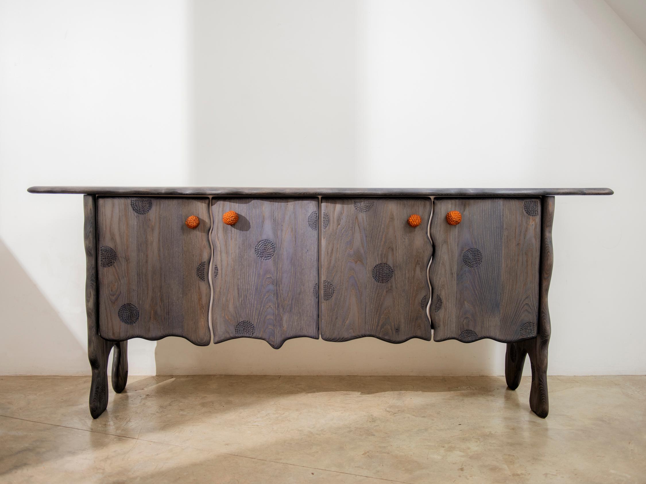 Saloon credenza by Luke Malaney
Dimensions: H 81.5 x D 46 x W 203 cm.
Materials: Pigmented Ash, Veneer Plywood. 

Luke Malaney designs and creates one of a kind pieces of furniture that are made to last. Using old world joinery, elegant design,