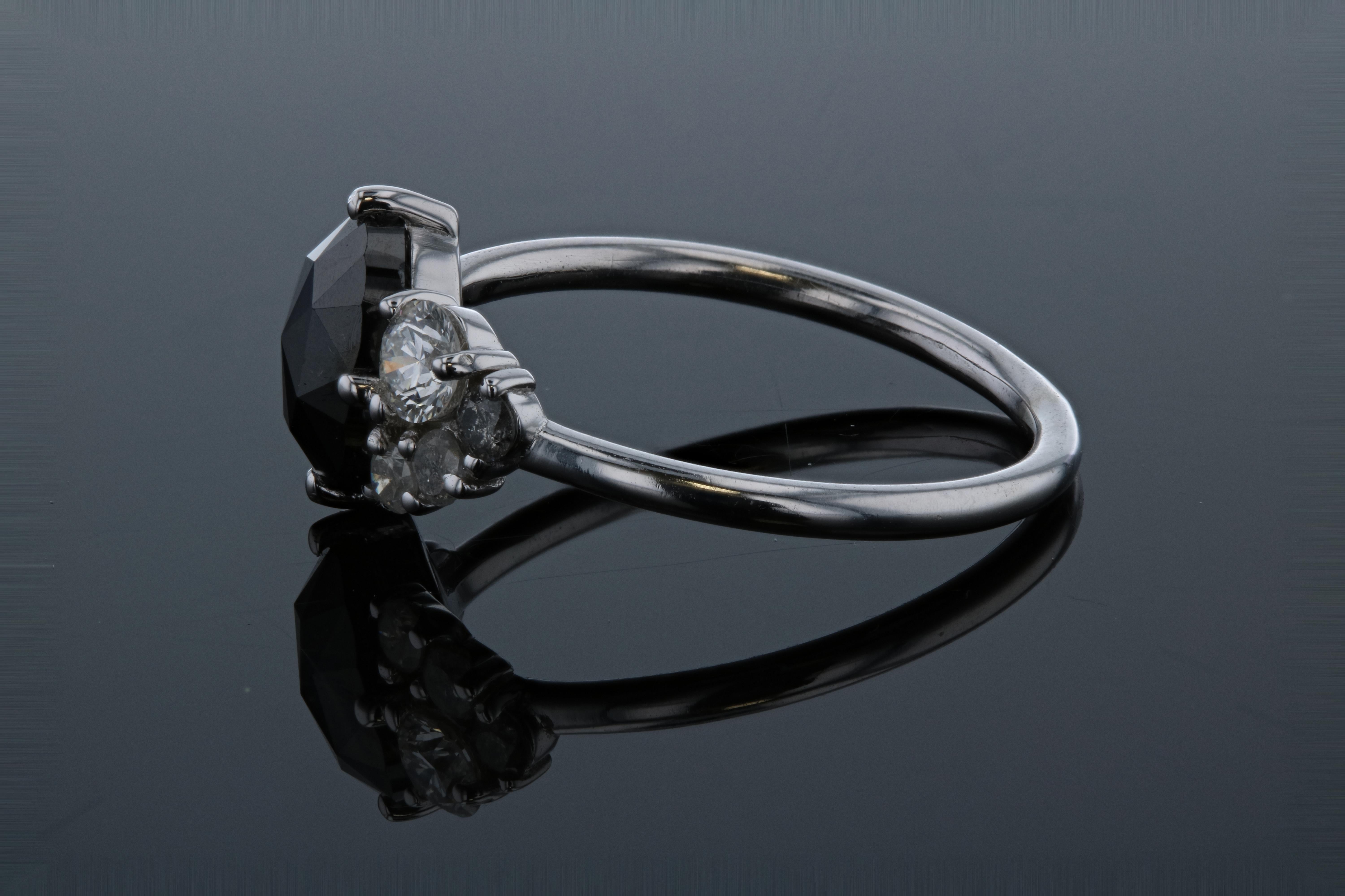This stunning black diamond salt and pepper diamond with matching wedding band is perfect for the modern bride. This diamond ring is crafted in 14kt white gold, & contains an Oval Diamond (1.29 total carat weight) surrounded by 5 round salt and