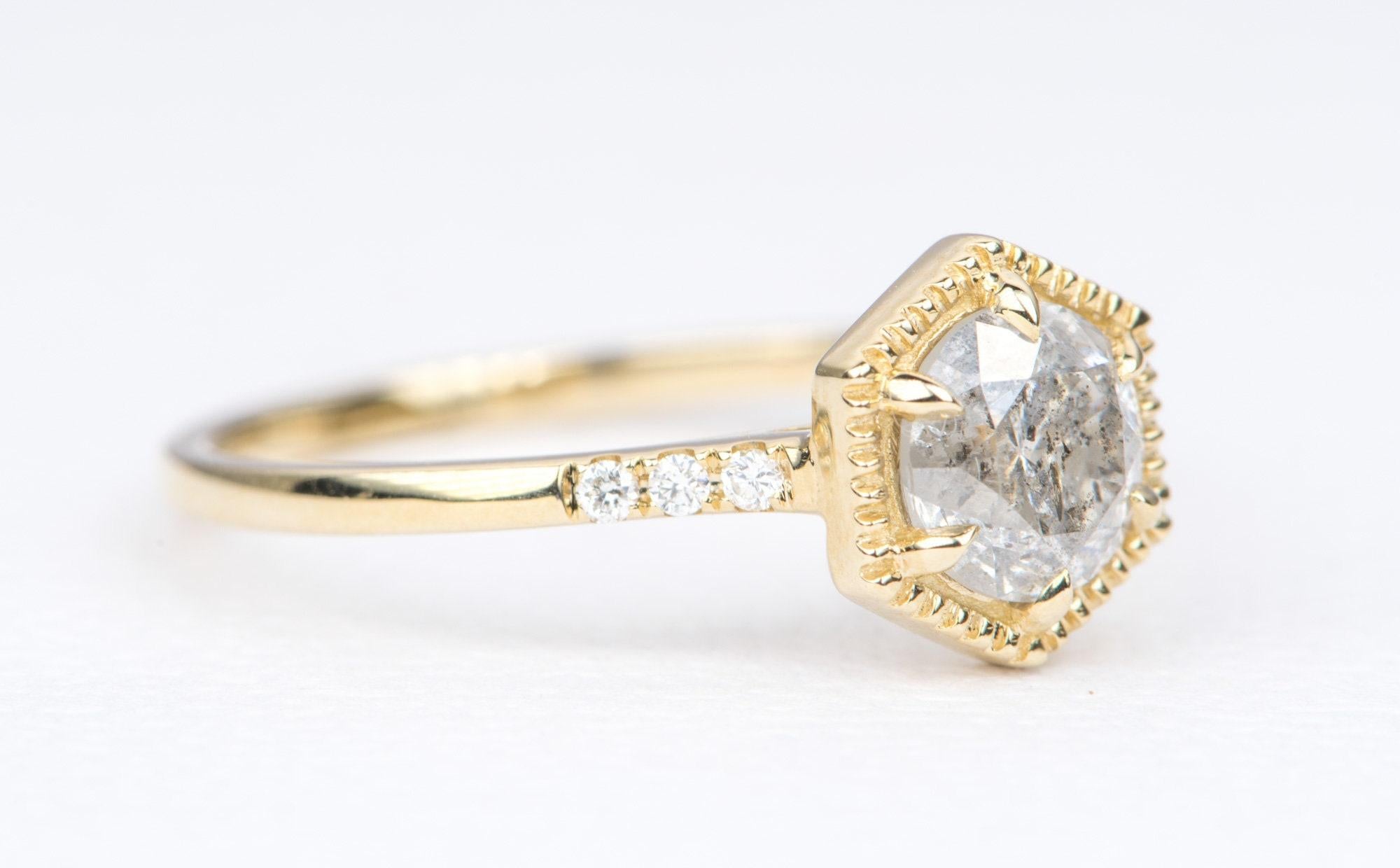 ♥  Solid 14K yellow gold ring set with a hexagon shaped round brilliant cut salt & pepper diamond in the center
♥  A milgrain edge setting surrounds the main stone and a trip of diamonds accent the band on each side
♥  The overall setting measures