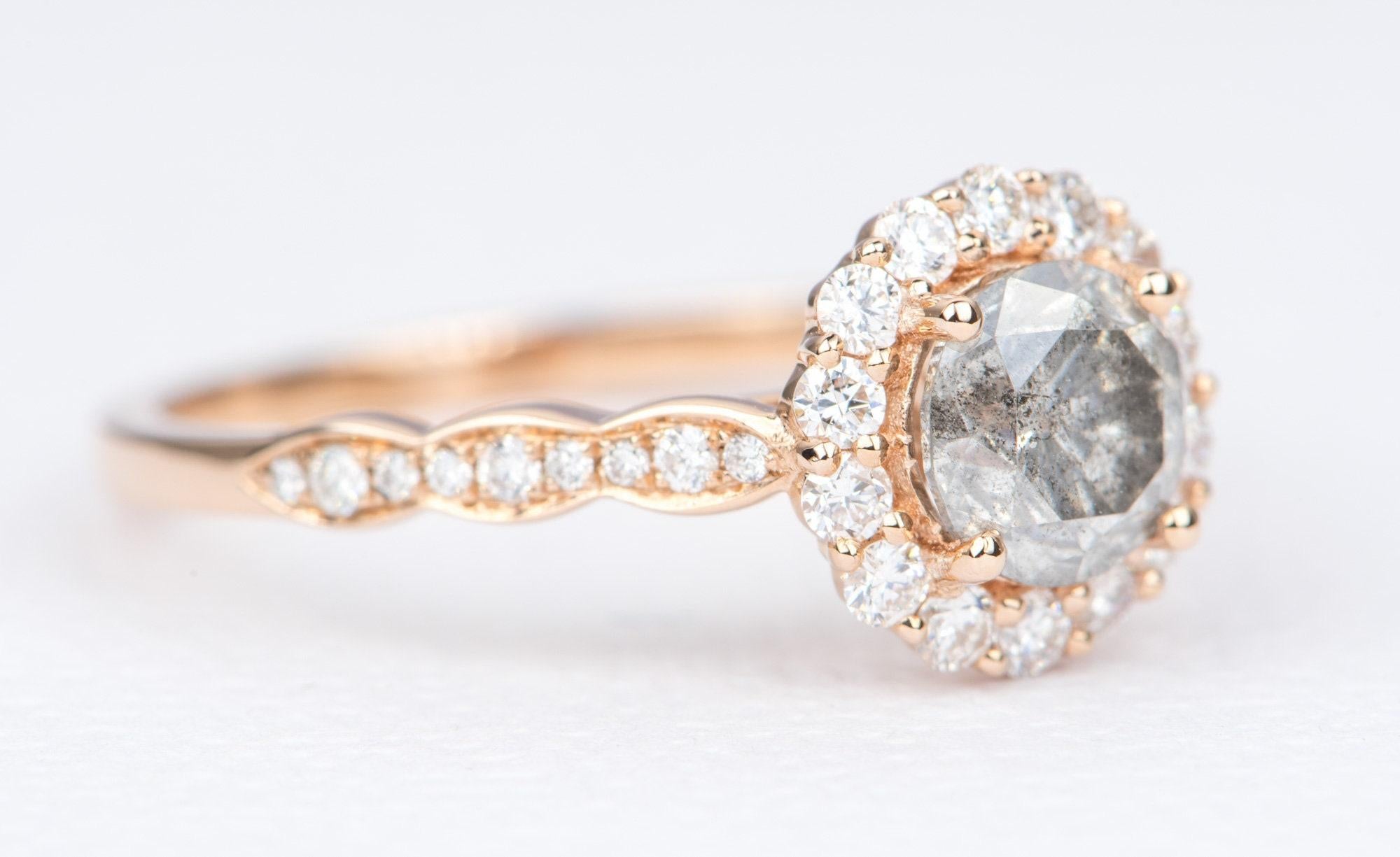 ♥  Solid 14K rose gold ring set with a round brilliant diamond in the center, then surrounded with a halo of white diamonds and a scallop style band set with sparkling diamonds
♥  The overall setting measures 9.1mm in width, 9.1mm in length, and