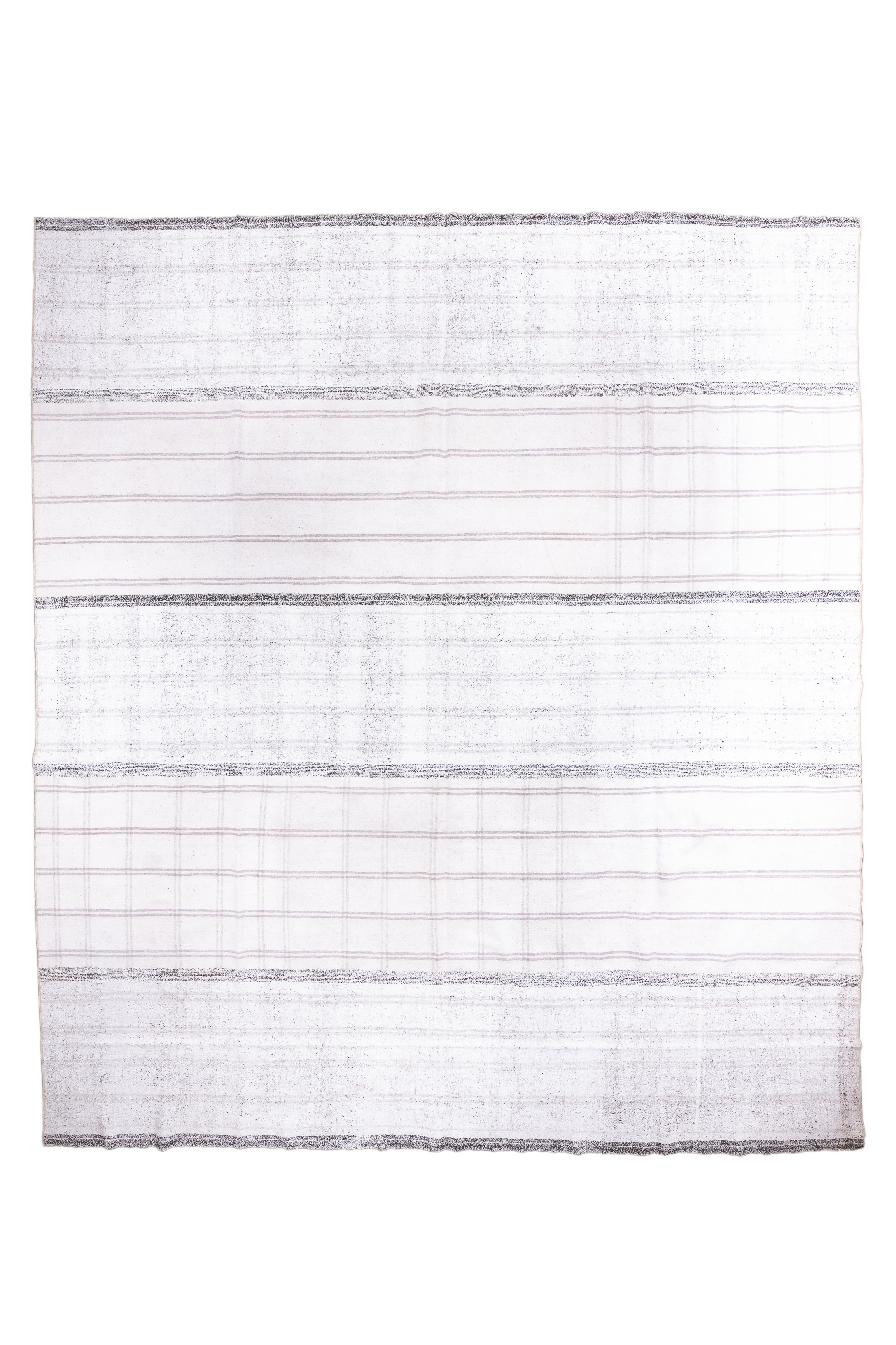 Now in five visual sections and originally a long band cut into five sections, in natural tones including cream and dark brown, in both pinstripes and speckled dark brown wider stripes. Warp faced wool weave. The ecru sections have traces of darker