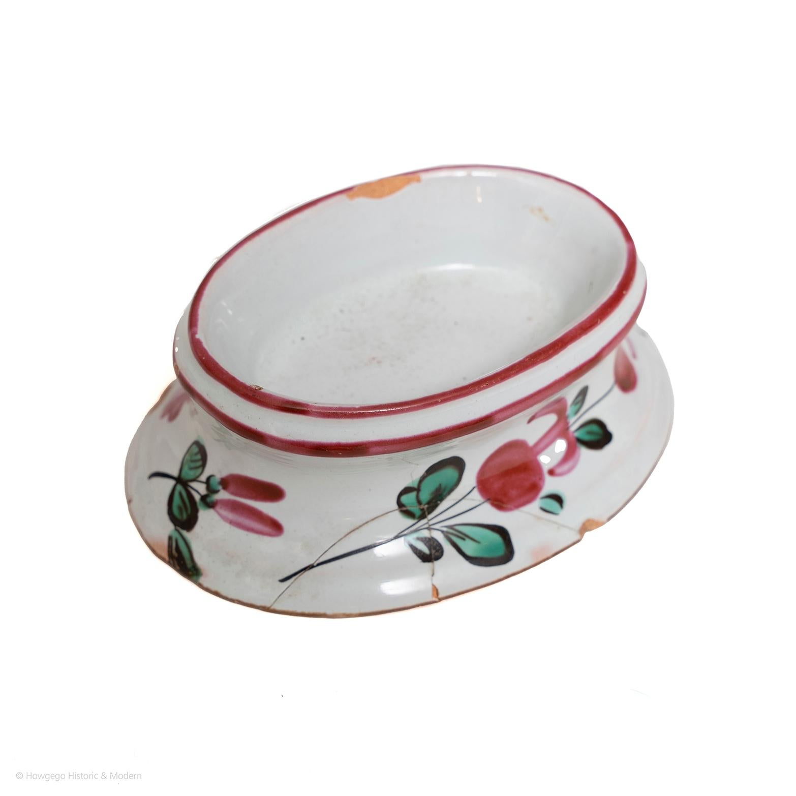 Rare surviving small piece of early tableware. Suitable for everyday use as a charming piece of history for the dining table.

two red bands around the top. the base decorated with two large floral sprays along the sides and the ends with two