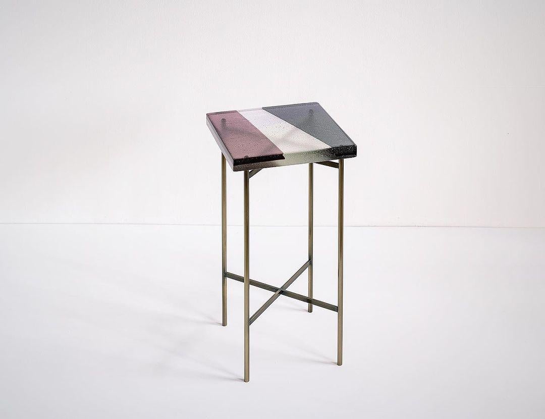 Salt Table by The GoodMan Studio
Dimensions: W 31 x D 31 x H 60 
Materials: Metal, Glass, Steel

Kilncast glass and steel base

SALT FRAMES
An exploration of the biology and geometry of salt fields using the medium of champagne glass. Inspired by