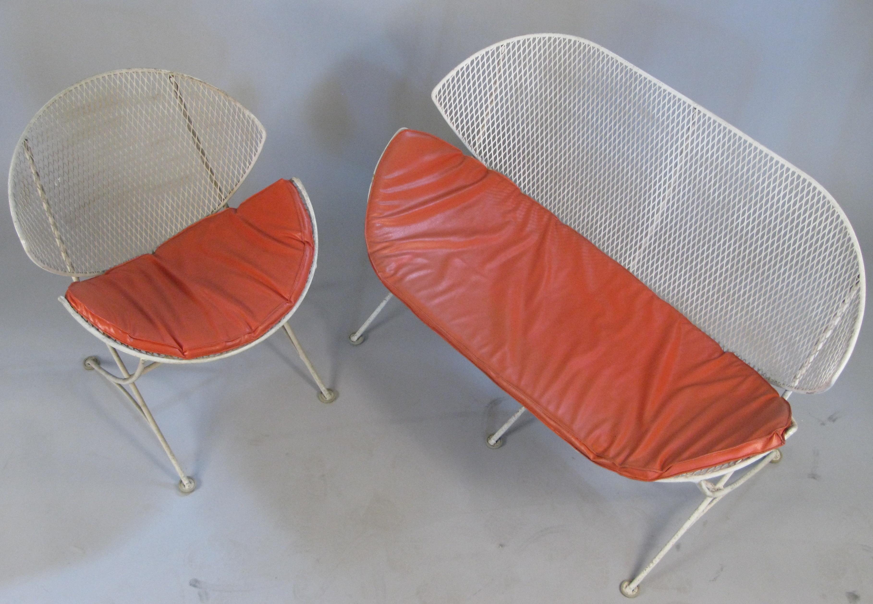 A vintage 1950s matching settee and lounge chair from the Orange Slice series by Salterini. These classic and iconic pieces are beautiful and comfortable. They are in their original white finish with age expected wear to the finish, and both pieces
