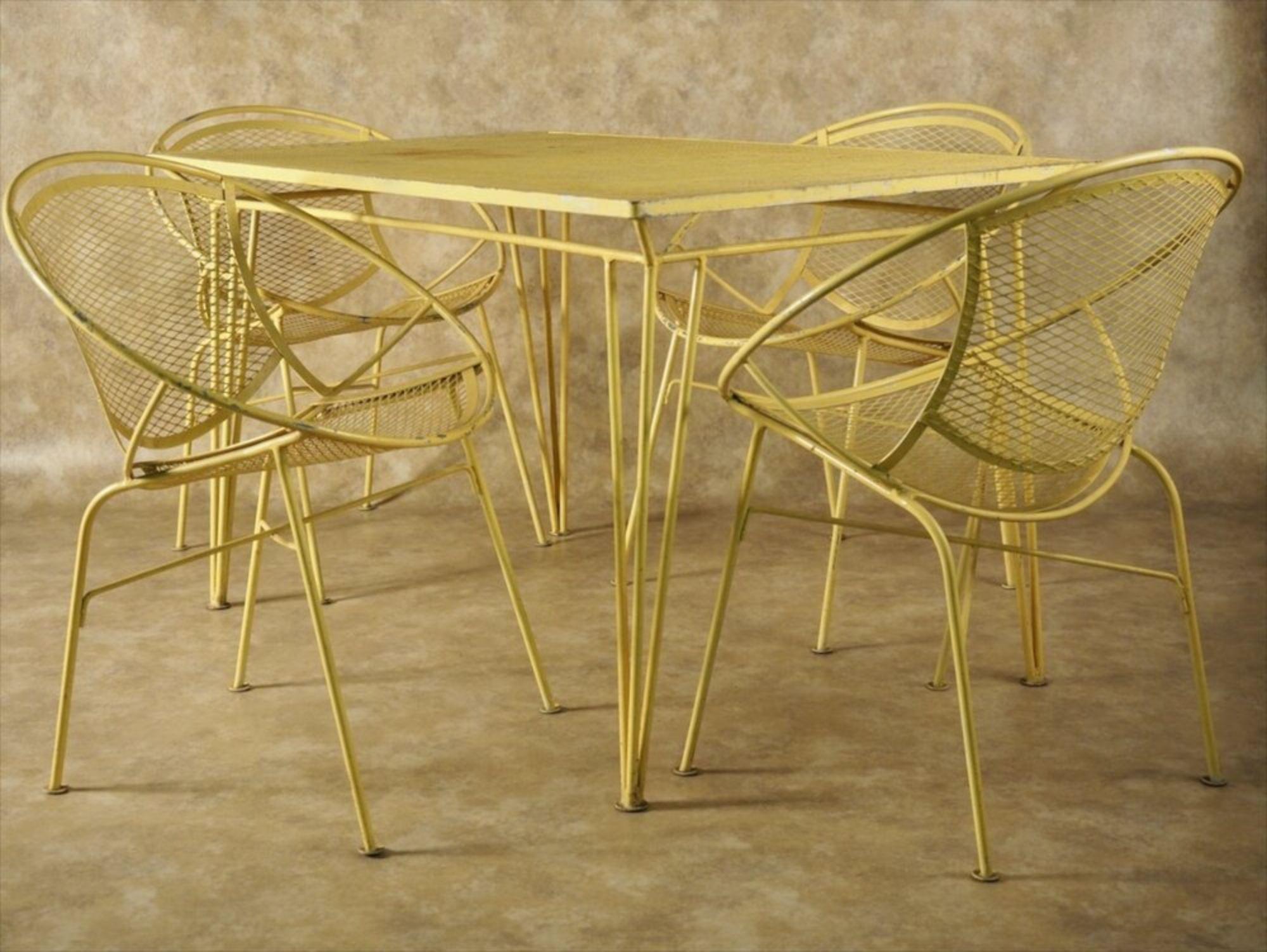 Mid-Century Modern dining table and four chairs in painted iron, by Salterini, circa 1960. Original yellow!

Measures: Table 48” wide x 30” deep x 28” high.

Chairs 25” wide x 21” deep x 30” high.