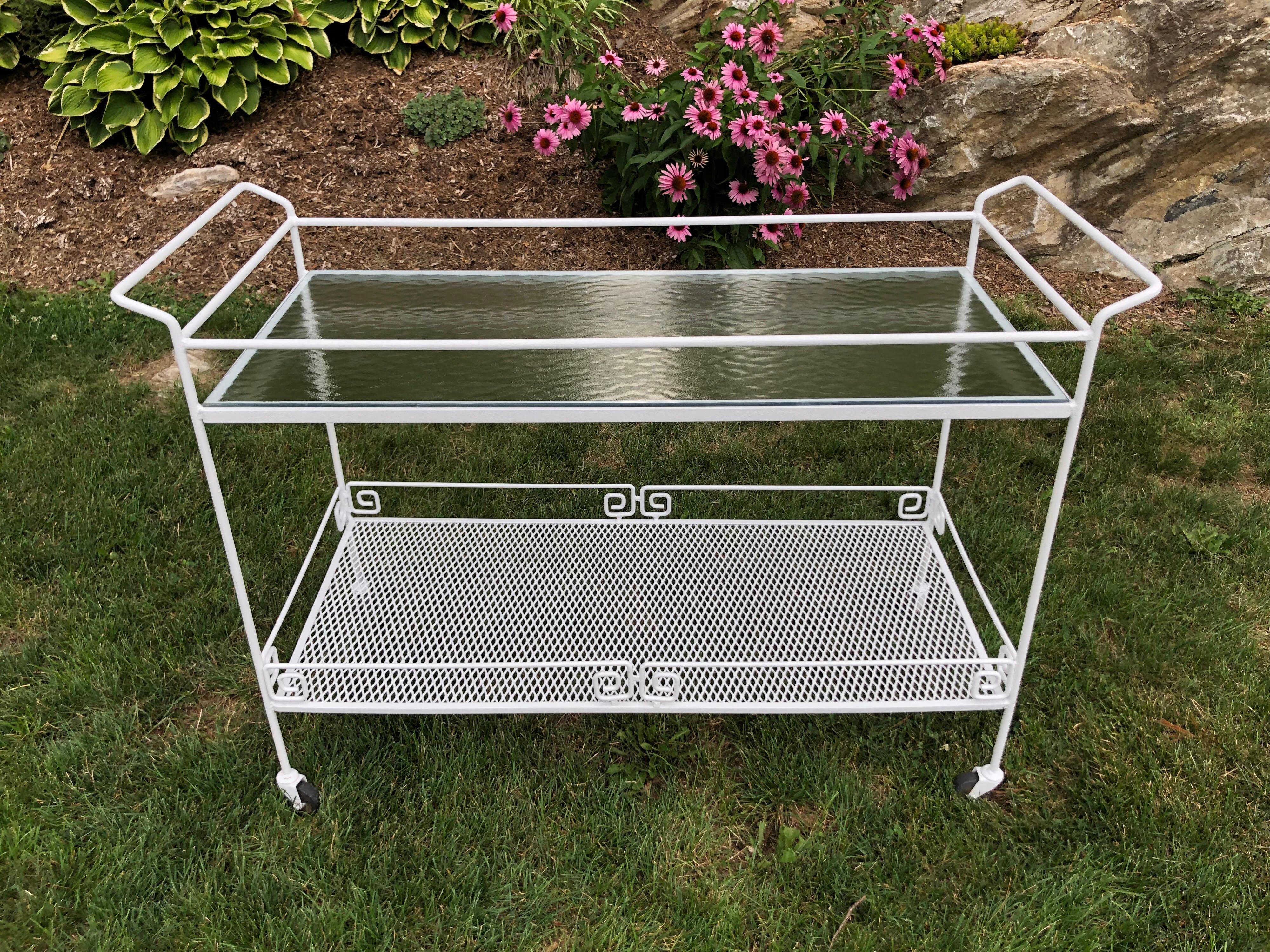 Salterini for Woodard Greek two tiered key bar cart. Perfect for entertaining. Easy to move with its nice castors. Freshly repainted in white. Original tempered glass top and weaved metal lower shelf. Nice size for a great party on the patio. We