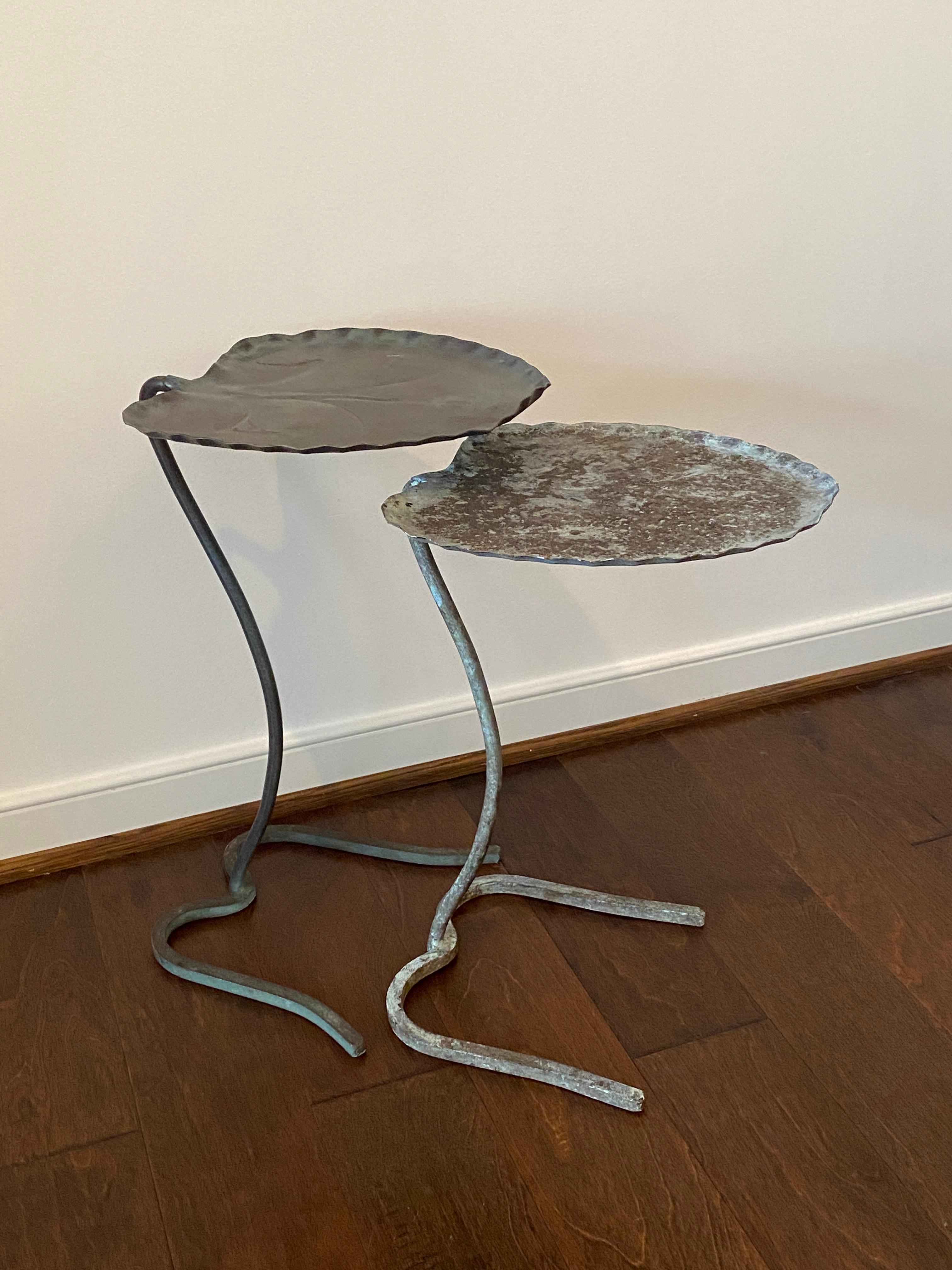 Listed is a stunning, pair of 1960s Salterini lily pad nesting tables. The pair have a beautiful, green verdigris finish. Handcrafted, solid-iron. Heavy, weighing nearly 11lbs total (Large: 5.5lbs. Small: 5lbs.). The smaller/shorter table has more