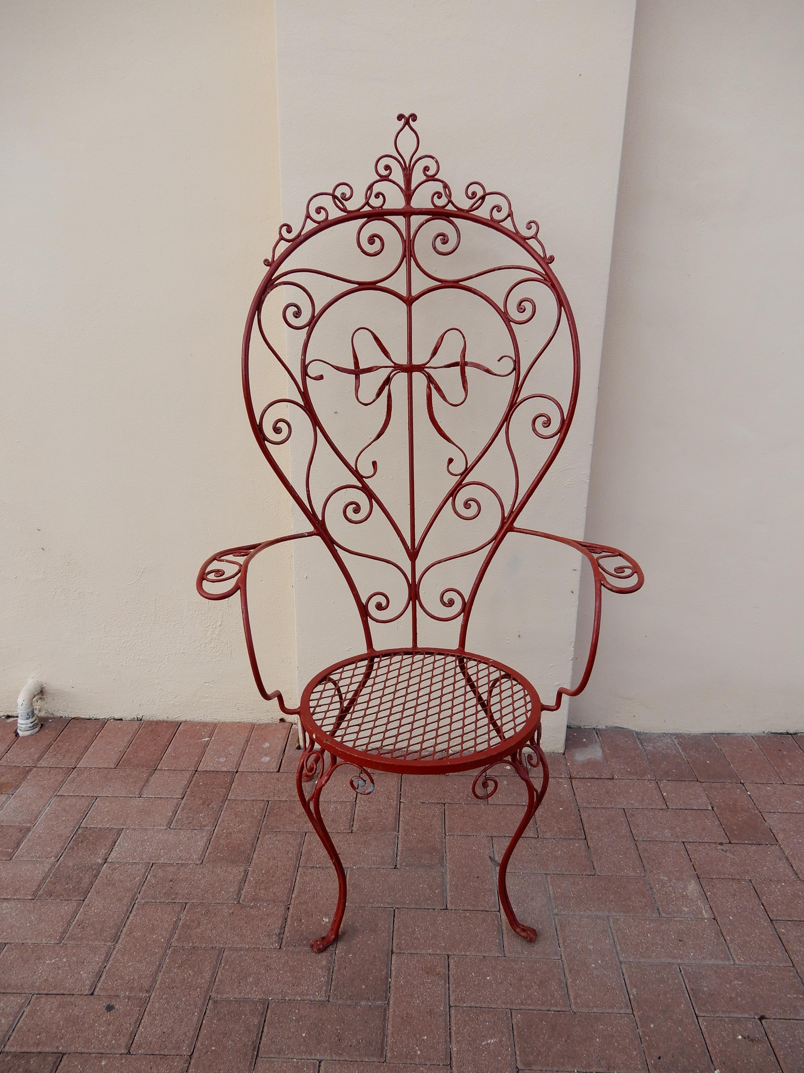 A wrought iron oversized armchair inspired by the work of 
John Salterini. There is a known Salterini armchair with a large ribbon in the center of the back, the ribbon in the chair shown here is most similar or copy. The oversized chair is