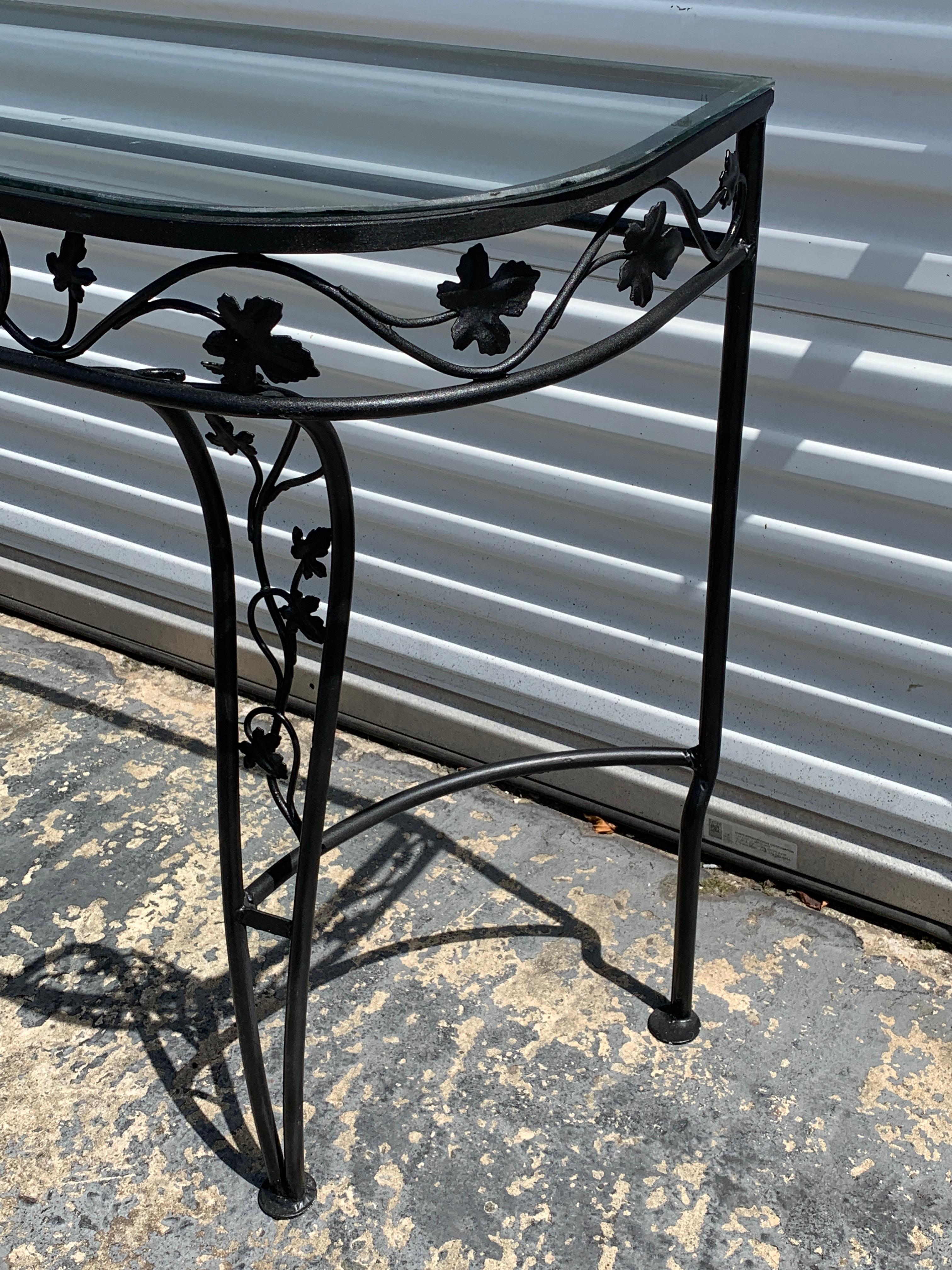 Salterini leaf and vine console table with glass top, of demilune form with clear glass top, a rare form.