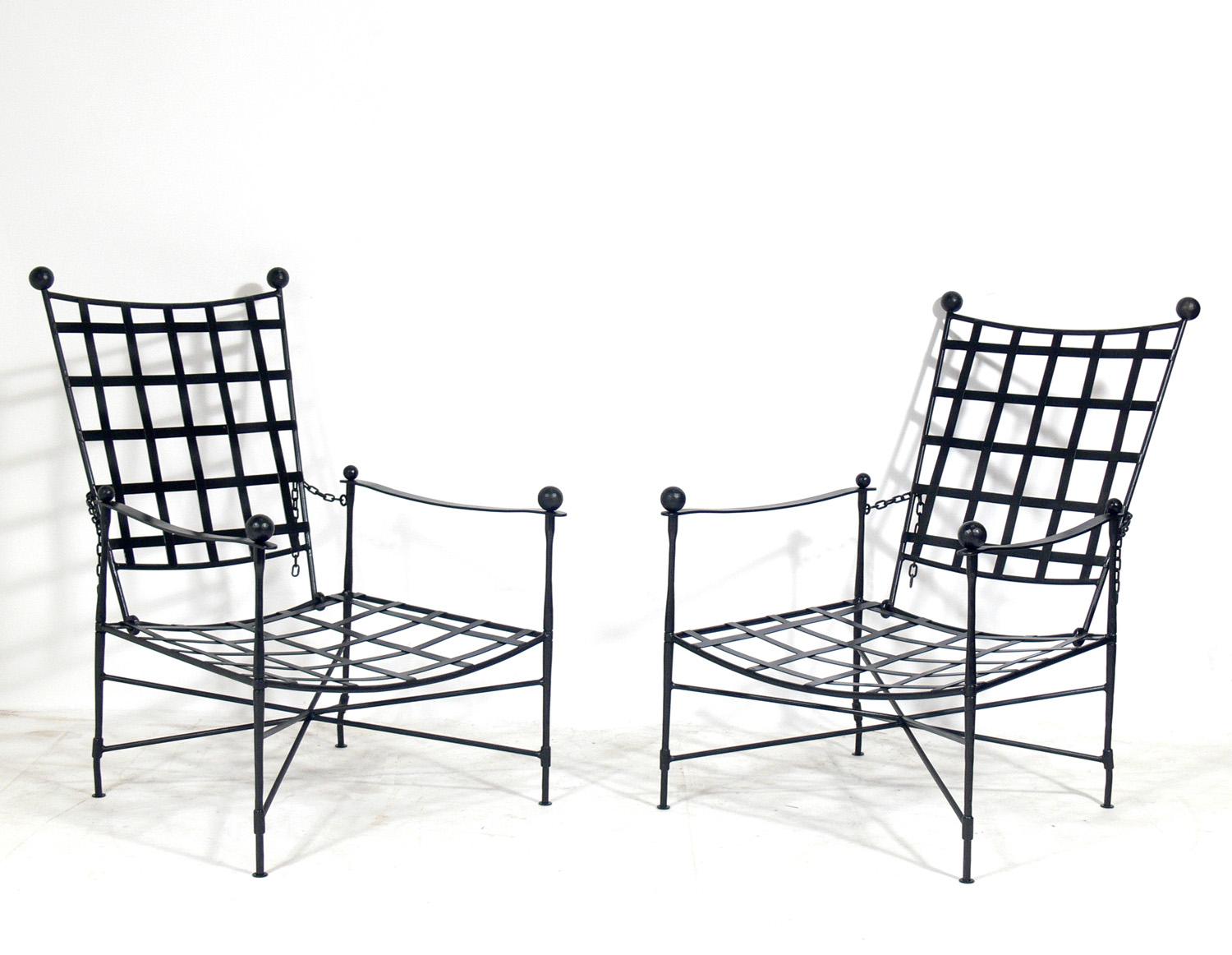 Pair of iron lounge chairs and single ottoman, design attributed to Mario Papperzini for Salterini, Italian, circa 1950s. This is a versatile form and it can be used indoors or outdoors. This sculptural chair design was used by Yves Saint Laurent in