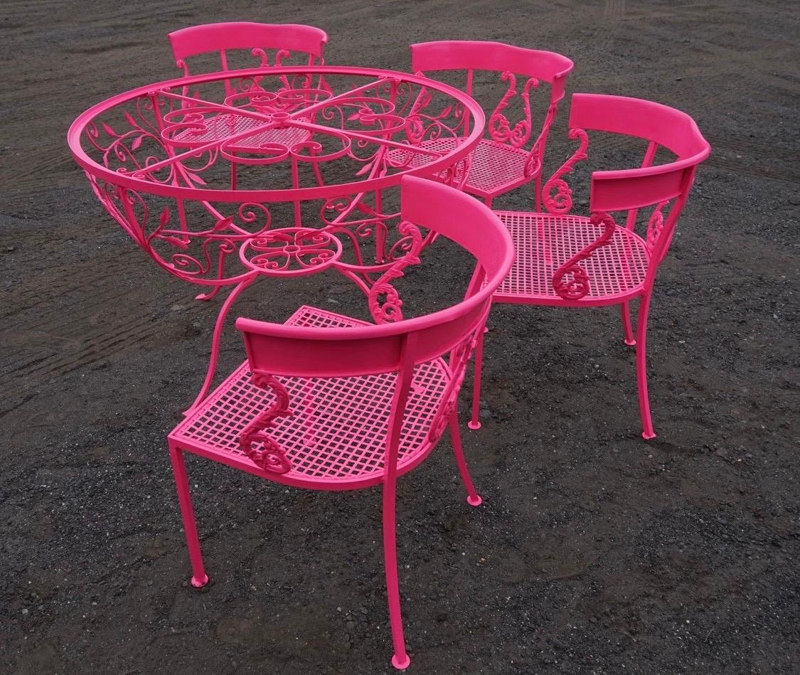 Iconic Salterini set which becomes a masterwork when it was powder-coated in a neon pink.
You will not find a more magnificent Salterini set! It comes with a ripple glass tabletop and an umbrella
stand as well. The chairs have the coveted Klismos
