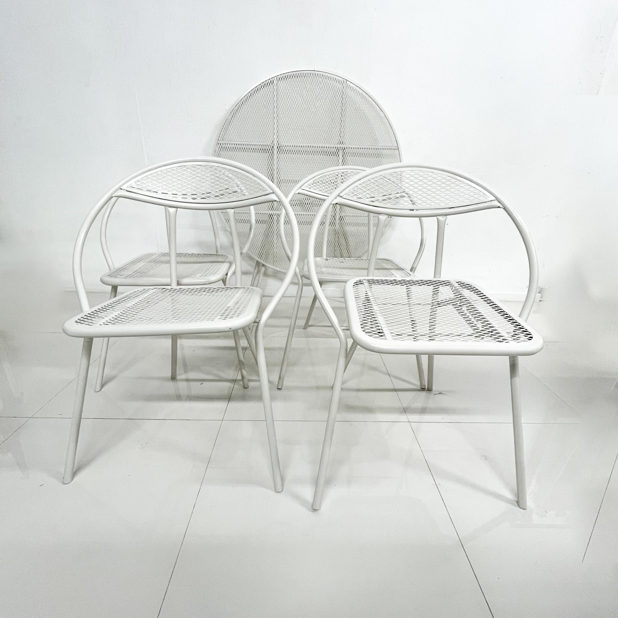 For your consideration a Mid-Century Modern dining set for the outdoors designed and produced by Salterini.

Restored with powder coated protective paint in off white color. 
Set includes four chairs and a round table. All the chairs and the