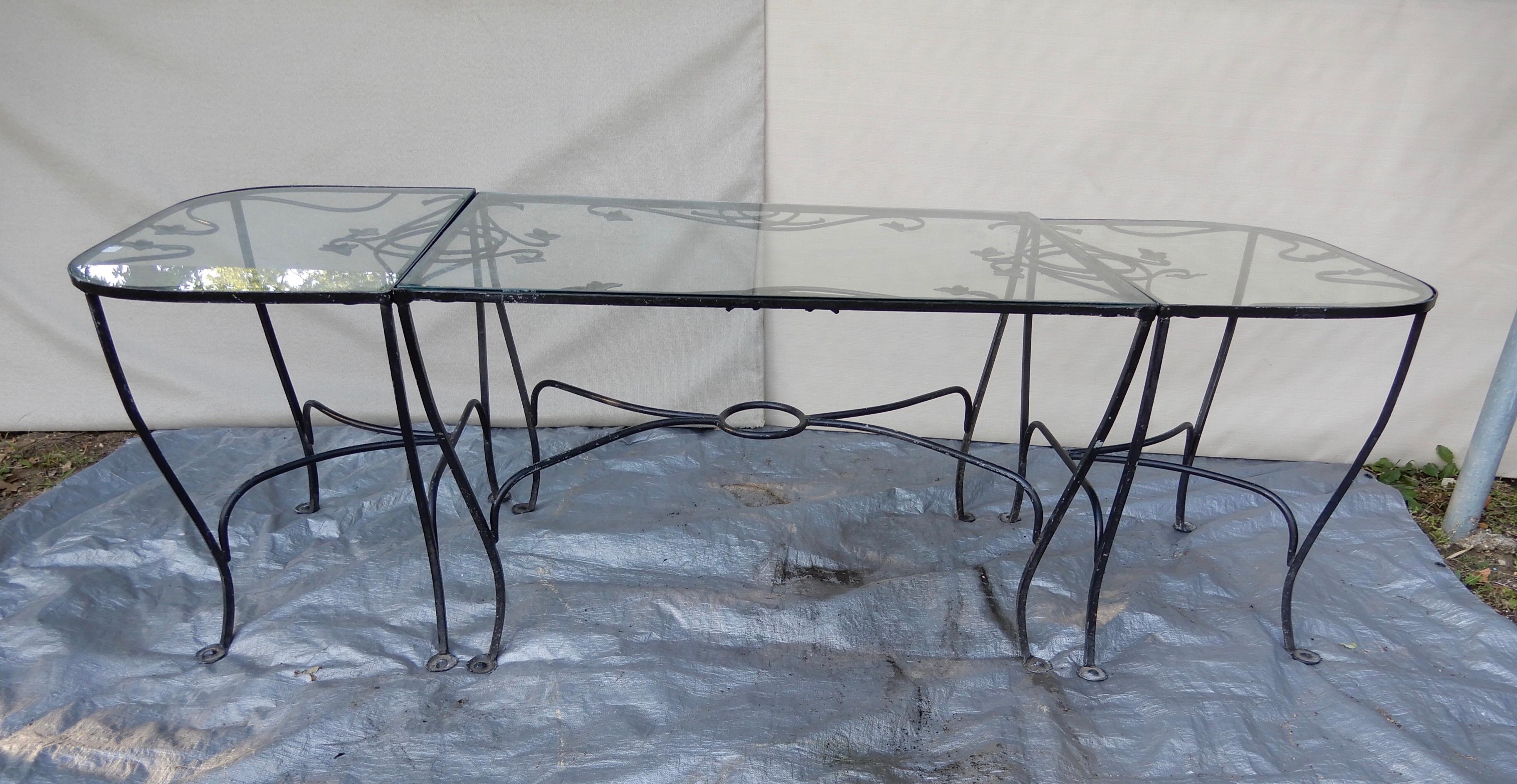 This is a Salterini wrought iron nine piece dining set in the desirable Mt Vernon pattern. It is comprised of three tables, a dining table that is 32 x 48, and a pair of console tables. The console tables can be used without the dining table in a